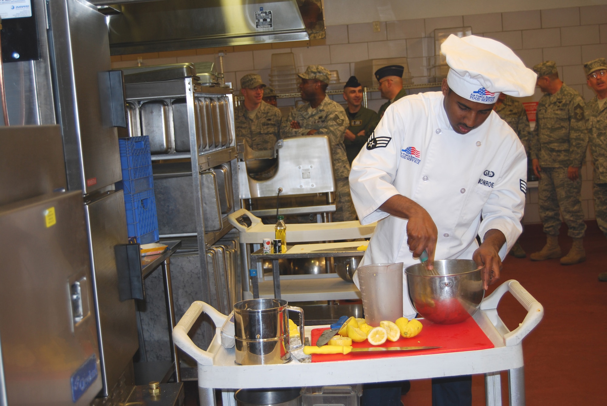 Senior Airman Maurice Monroe whisks together ingredients while preparing his “Col. Cotton Lemon Bars,” half of the winning dish he and his partner prepared..(U.S Air Force photo/Airman 1st Class Kristina Overton)