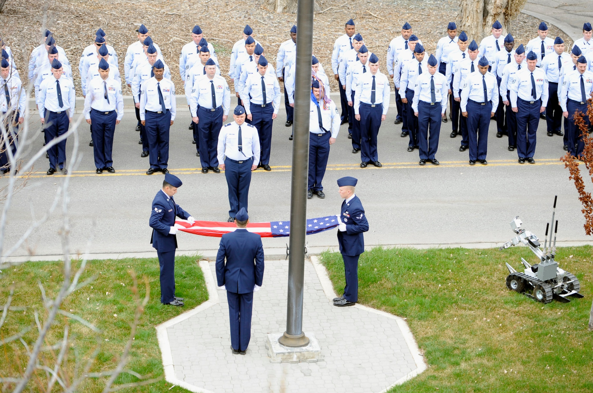 MOUNTAIN HOME AIR FORCE BASE, Idaho -- Airmen from the 366th Civil Engineering Squadron stand at attention as the colors are folded during a retreat ceremony held in front of the 366th Fighter Wing Headquarters March 29. 366th CES hosted the retreat in memory of Tech. Sgt. Walt Moss, 366th CES explosive ordnance disposal apprentice. Sergeant Moss was the first United States Air Force EOD Airman to be killed in combat since the start of OEF and OIF, and was killed near Baghdad during safing operations. (U.S. Air Force photo by 1st Lt. Neil Samson)