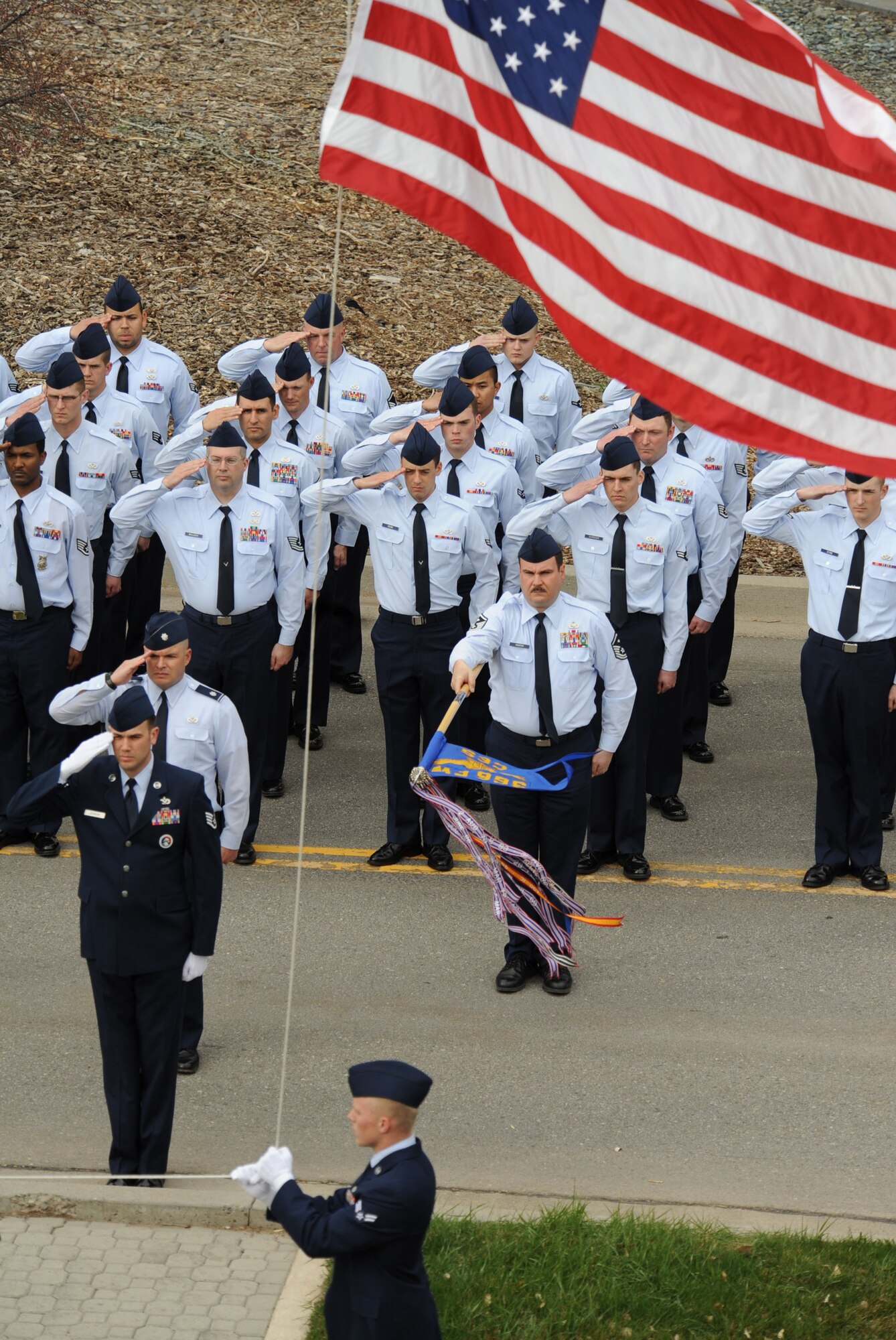 MOUNTAIN HOME AIR FORCE BASE, Idaho -- Airmen from the 366th Civil Engineering Squadron salute the colors during a retreat ceremony at the Fighter Wing Headquarters March 29. 366th CES hosted the retreat in memory of Tech. Sgt. Walt Moss, 366th CES explosive ordnance disposal apprentice. Sergeant Moss was the first United States Air Force EOD Airman to be killed in combat since the start of OEF and OIF, and was killed near Baghdad during safing operations. (U.S. Air Force photo by Airman 1st Class Renishia Richardson)