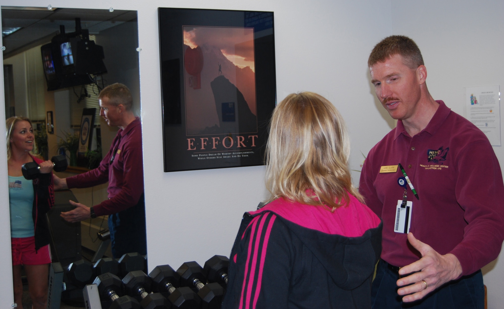 Kirk Clark, HAWC exercise physiologist, helps Tech. Sgt. Sarah Edwards, Women’s Health non-commissioned officer in charge with proper lifting technique at the Health and Wellness Center March 30. The facility is available for health and fitness assessments, awareness and prevention intervention and exercise prescriptions.(U.S. Air Force photo/Airman 1st Class Kristina Overton)