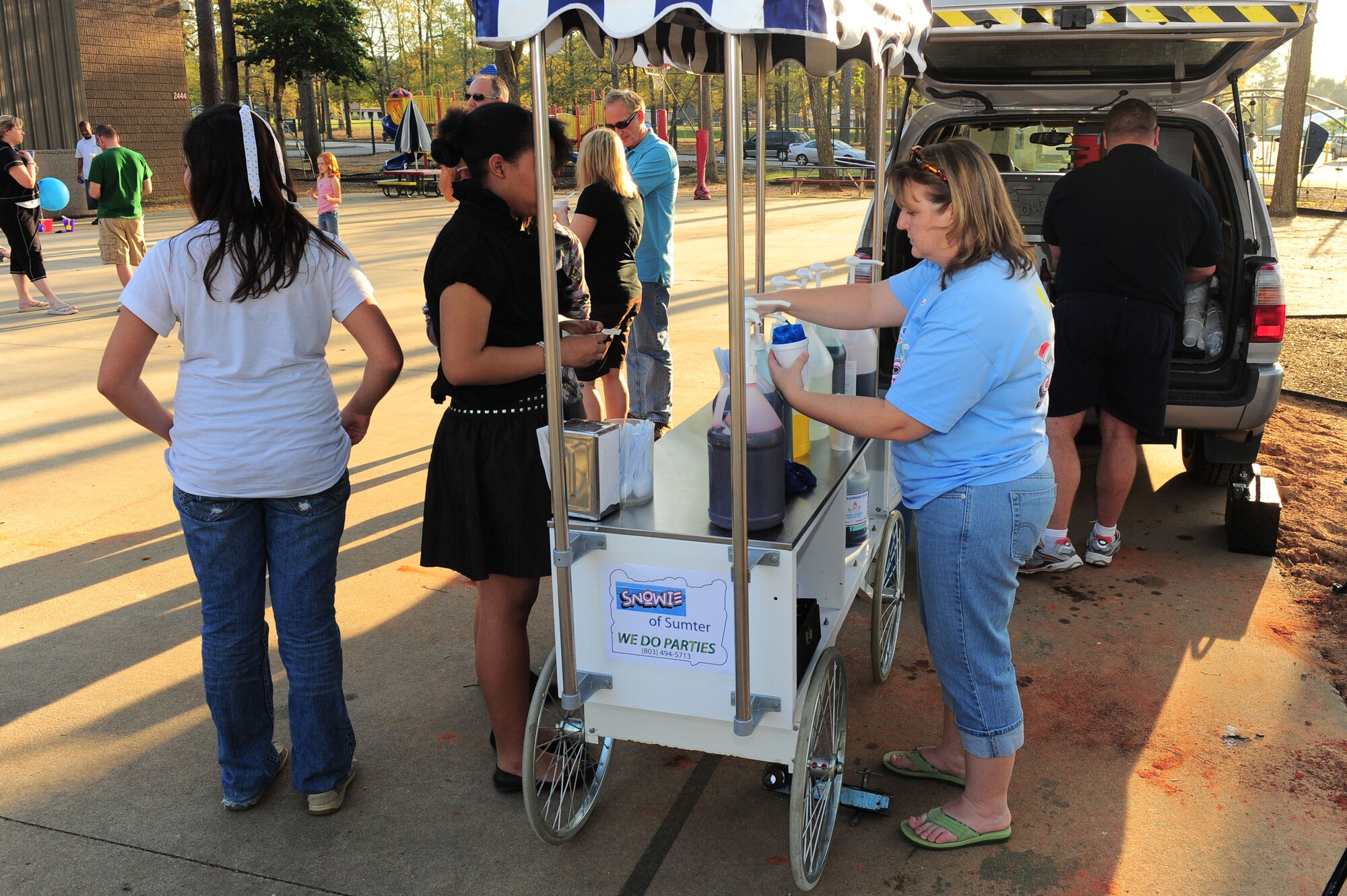 SHAW AIR FORCE BASE, S.C. -- Jesse Voison and Lisa Voison, Snowie of Sumter operators, make Sno Balls for the children during the Month of the Military Child carnival here April 1. (U.S Air Force photo/Senior Airman David Minor)