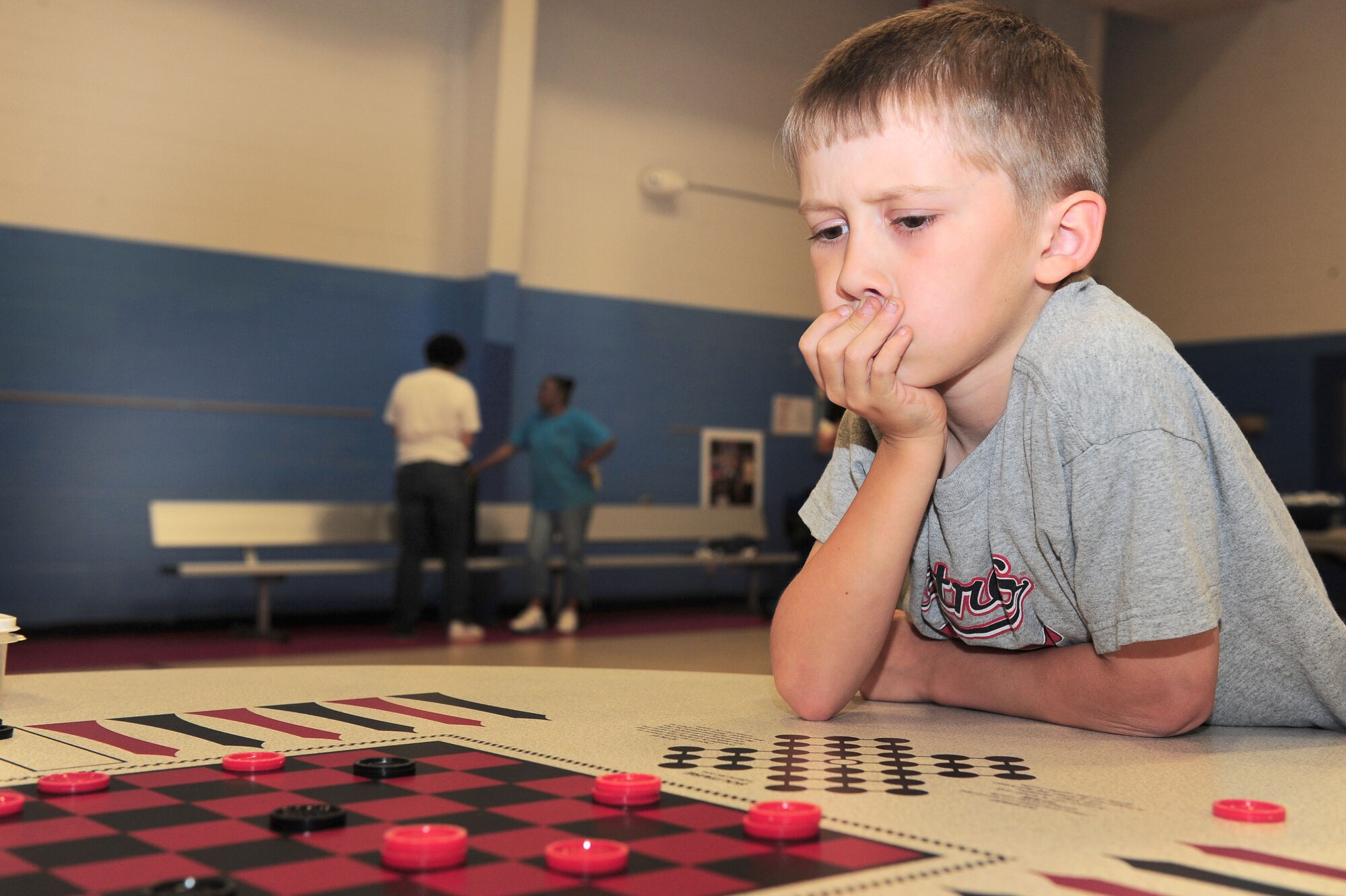 SHAW AIR FORCE BASE, S.C. -- Ryan Essigmann, age 9, son of Staff Sgt. Richard Essigmann, 20th Equipment Maintenance Squadron munitions inspector, contemplates  his next move during a game of checkers at the Month of the Military Child carnival here April 1. (U.S Air Force photo/Senior Airman David Minor)