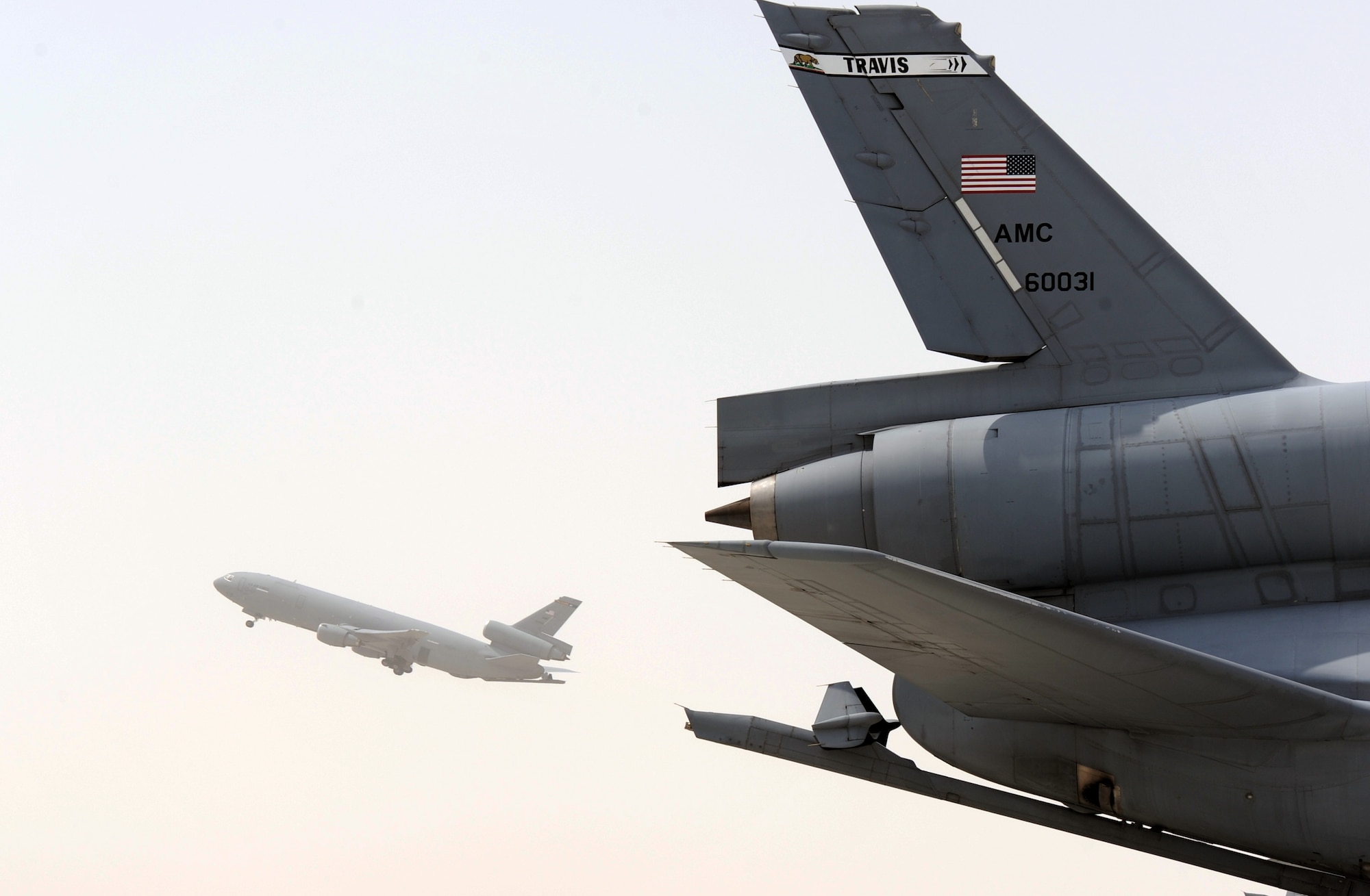 A KC-10 Extender departs for a mission in view of another KC-10 during operations for the 380th Air Expeditionary Wing at a non-disclosed base in Southwest Asia on March 27, 2010. The deployed KC-10s are assigned to the 908th Expeditionary Air Refueling Squadron and are deployed from Joint Base McGuire-Dix-Lakehurst, N.J., and Travis Air Force Base, Calif. The 908th EARS is the only deployed KC-10 air refueling squadron in the U.S. Central Command area of responsibility and as part of the 380th AEW supports operations Iraqi Freedom and Enduring Freedom and the Combined Joint Task Force-Horn of Africa. (U.S. Air Force Photo/Master Sgt. Scott T. Sturkol/Released)