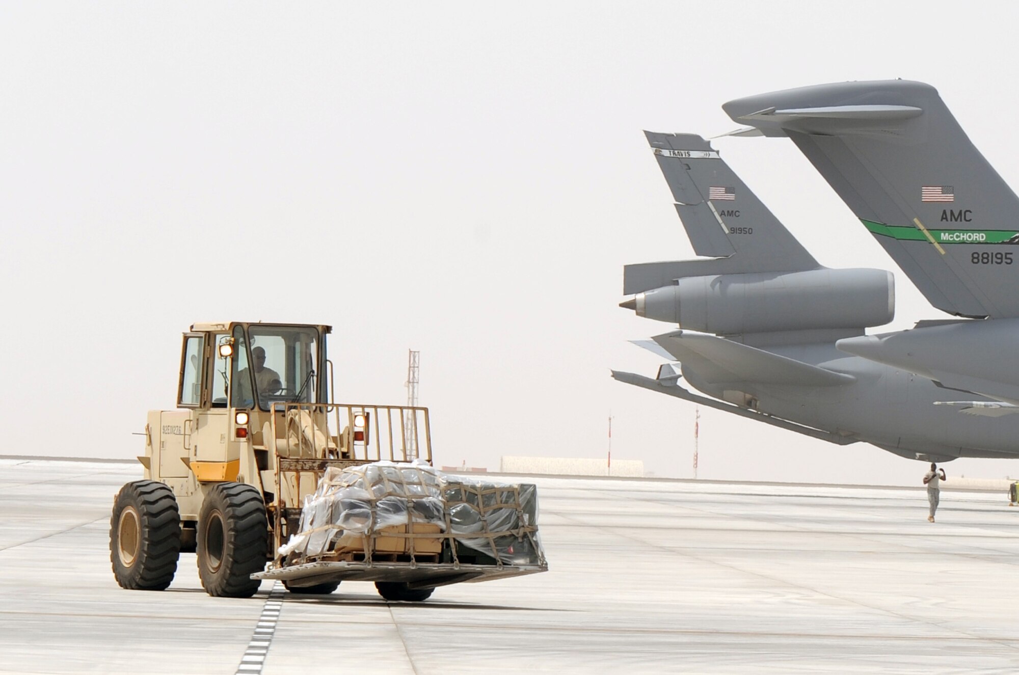 An air transportation Airman from the 380th Expeditionary Logistics Readiness Squadron's Air Terminal Operations Center drives an extreme-terrain forklift carrying a pallet of cargo for a C-17 Globemaster III during operations on the flightline for the 380th Air Expeditionary Wing at a non-disclosed base in Southwest Asia on March 27, 2010. All of the air transportation Airmen with the 380th ELRS are deployed from the 89th Aerial Port Squadron at Joint Base Andrews, Md. The 380th AEW supports operations Iraqi Freedom and Enduring Freedom and the Combined Joint Task Force-Horn of Africa. (U.S. Air Force Photo/Master Sgt. Scott T. Sturkol/Released)