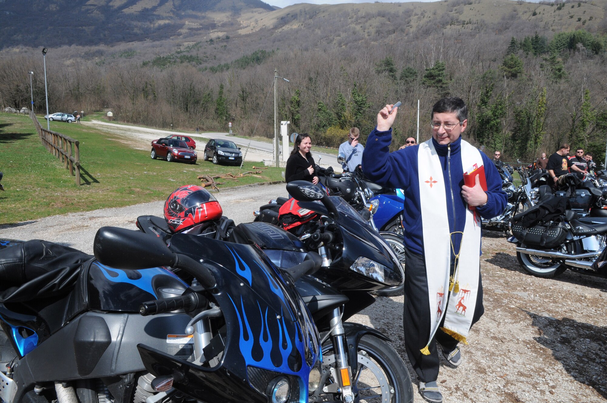 After the prayer was said, the priest from Moudonna del Monte-"Holy Lady of the Mountain" Church, blessed each bike with holy water. Approximately 85 bikes and 115 riders railed for the event on March 27. (U.S. Air Force Photo/Staff Sgt. MercedesKimble L. Crossland)