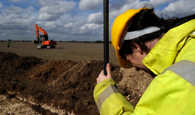 RAF MILDENHALL, England – Mike Feider, Suffolk County Council archaeology service, marks global positioning satellite coordinates as part of an exploratory dig to see if artifacts are in the area.  British law states that an exploratory excavation must be carried out before construction can be done in an area to help preserve historic heritage.  (U.S. Air Force photo/Staff Sgt. Christopher L. Ingersoll)