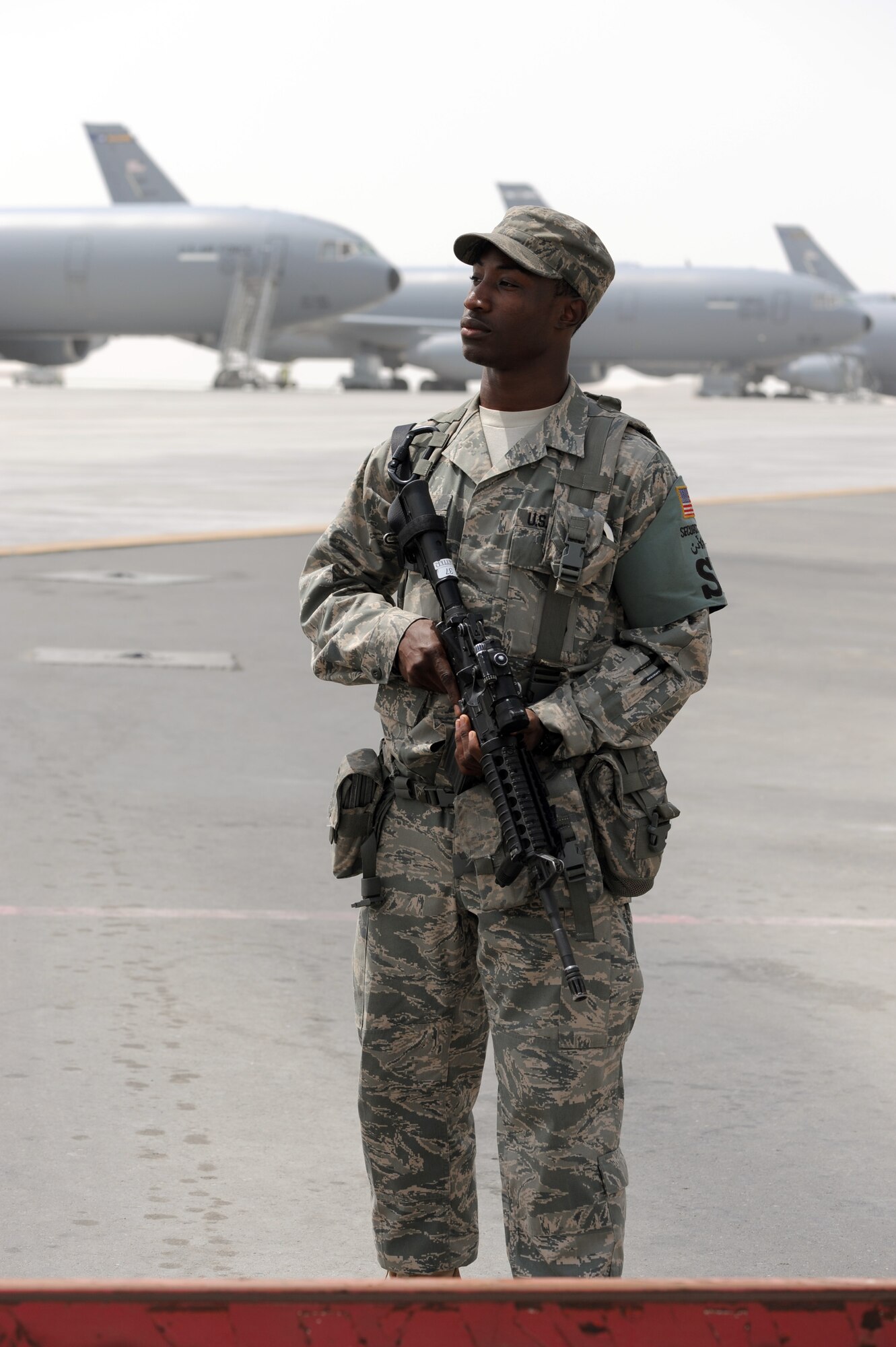 Senior Airman Michael Better, security forces journeyman with the 380th Expeditionary Security Forces Squadron, watches over a checkpoint near the flightline at a non-disclosed base in Southwest Asia on March 27, 2010. As a security forces Airman, Airman Better supports all security and force protection efforts for a deployed wing of more than 1,900 people and for billions of dollars worth of Air Force equipment and assets. He is deployed from the 628th Security Forces Squadron at Joint Base Charleston, S.C., and his hometown is Baltimore City, Md. (U.S. Air Force Photo/Master Sgt. Scott T. Sturkol/Released) 