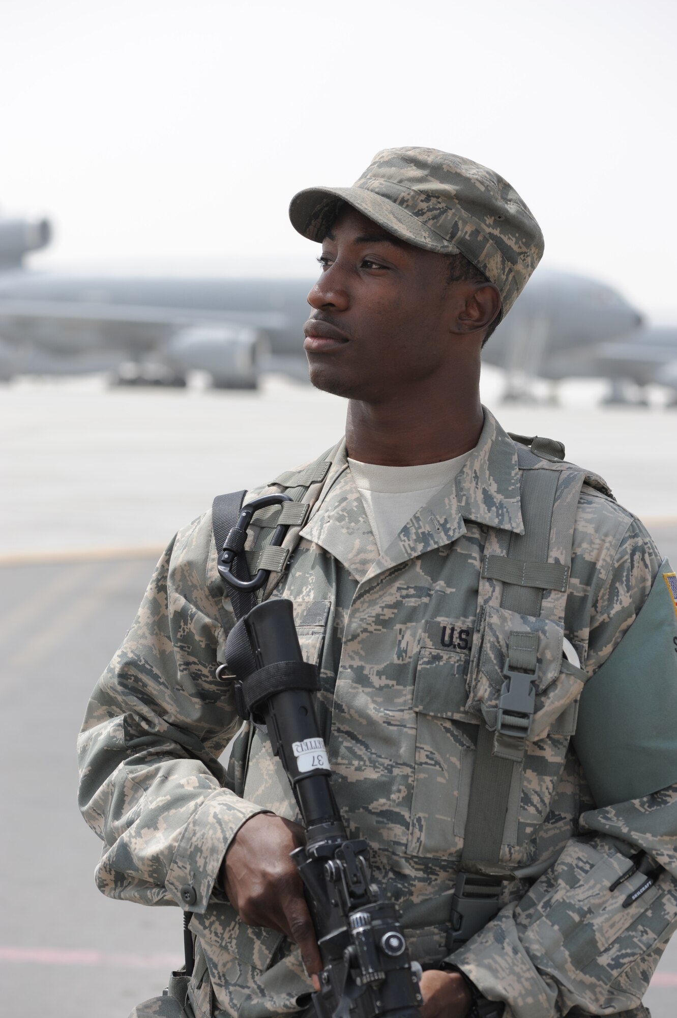 Senior Airman Michael Better, security forces journeyman with the 380th Expeditionary Security Forces Squadron, watches over a checkpoint near the flightline at a non-disclosed base in Southwest Asia on March 27, 2010. As a security forces Airman, Airman Better supports all security and force protection efforts for a deployed wing of more than 1,900 people and for billions of dollars worth of Air Force equipment and assets. He is deployed from the 628th Security Forces Squadron at Joint Base Charleston, S.C., and his hometown is Baltimore City, Md. (U.S. Air Force Photo/Master Sgt. Scott T. Sturkol/Released) 