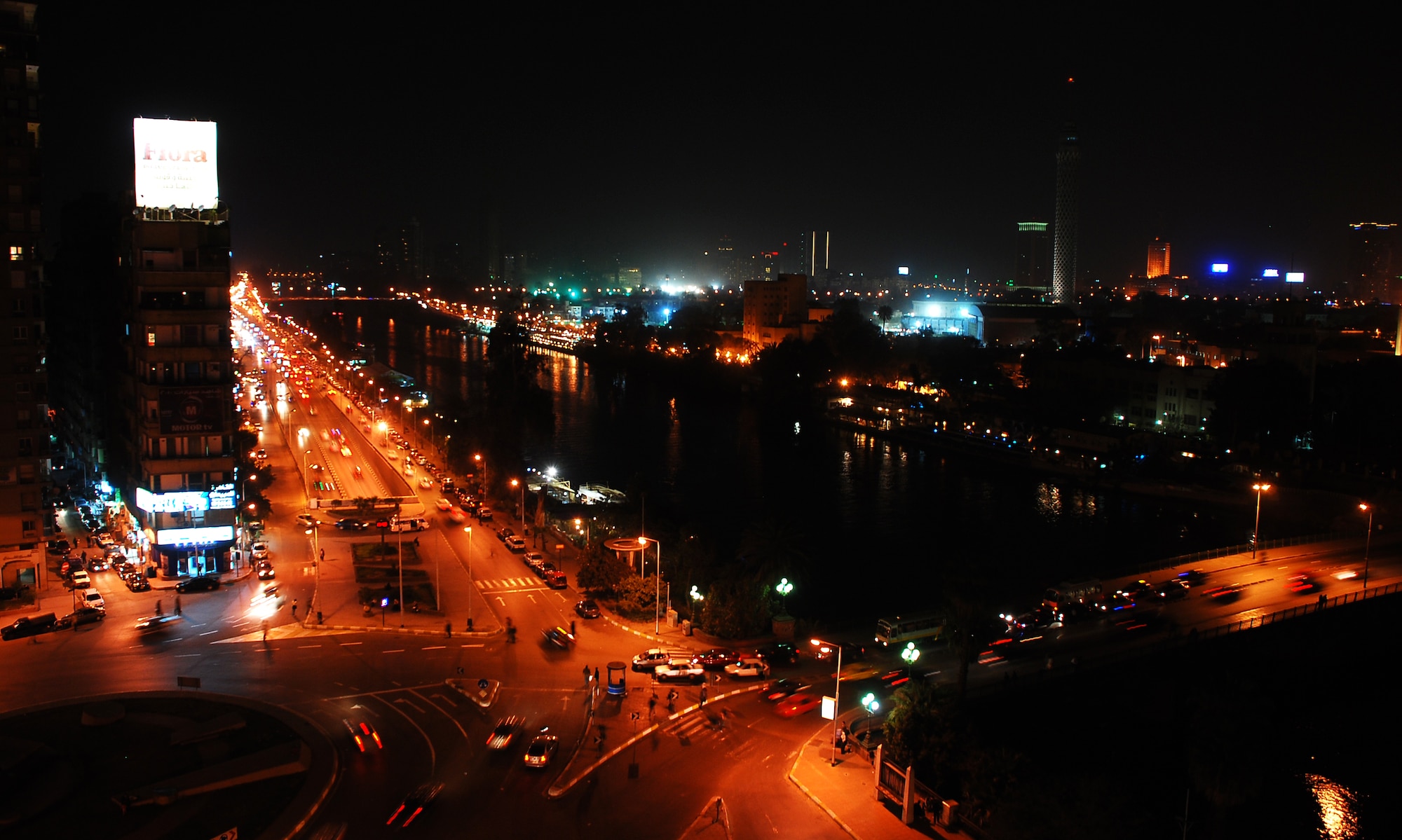 Cars crisscross through the inner city of Cairo Egypt, alongside the Nile River at night.  Cairo is the capital of Egypt and the largest city in Africa as well as one of the most densely populated cities in the world. Cairo is the center of the region’s political and cultural life and is largely associated with Ancient Egypt due to the proximity of the Great Sphinx and the Pyramids of Giza. (U.S. Air Force photo/Senior Airman Sara Csurilla)
