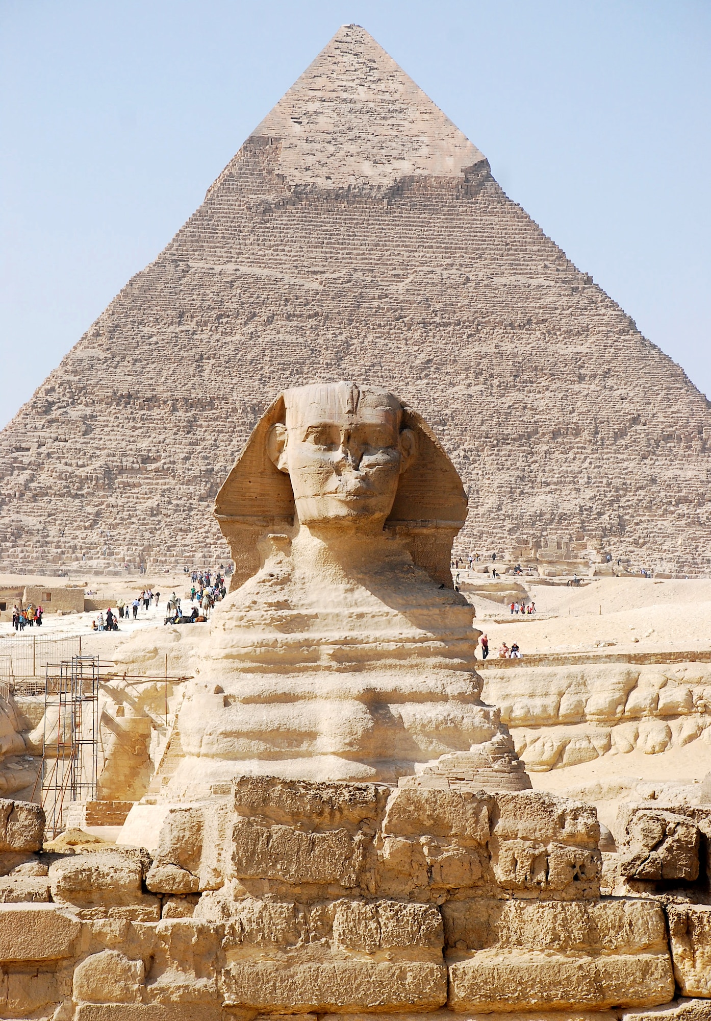 The Great Sphinx of Giza lies on the Giza Plateau with the famous Pyramids of Giza just in the distance, near Cairo, Egypt. The Sphinx is a statue of a reclining lion with a human head that is believed to have been built by ancient Egyptians between 2555 B.C. and 2523 B.C. It is one of the most famous and recognizable pieces of history in the Cairo area. (U.S. Air Force photo/Senior Airman Sara Csurilla)