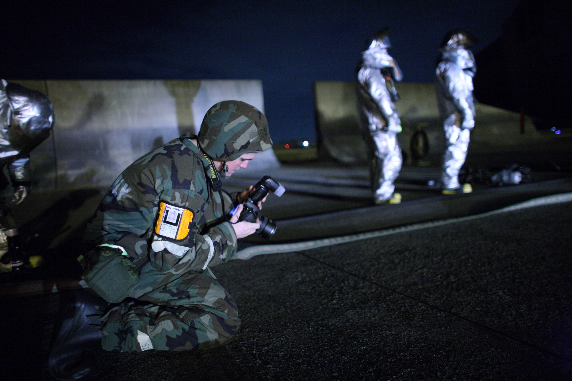 YOKOTA AIR BASE, Japan -- Airman 1st Class Sean Martin, 374th Airlift Wing, checks camera settings before capturing images here Mar. 31.  Yokota conducted an exercise 28 Mar. through 1 Apr. to help maintain operational readiness.  (U.S. Air Force photo/Osakabe Yasuo)