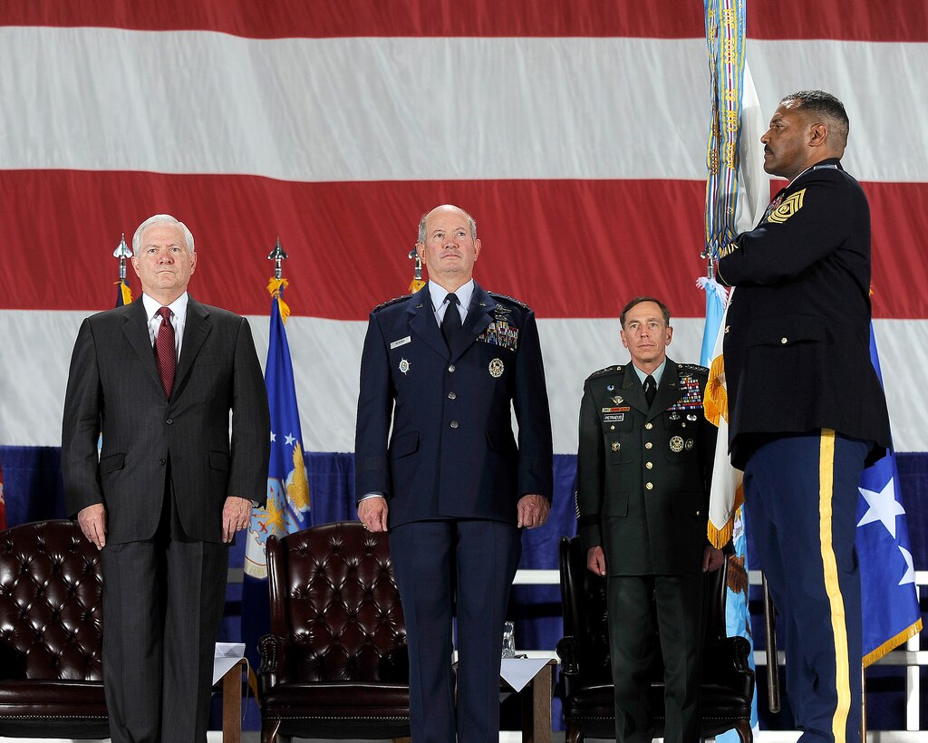 U.S. Defense Secretary Robert M. Gates and U.S. Air Force General Duncan McNabb, commander of U.S. Transportation Command, stand at attention during a ceremony to present Transcom the Joint Meritorious Unit Award, Scott Air Force Base, Ill., April 1, 2010.