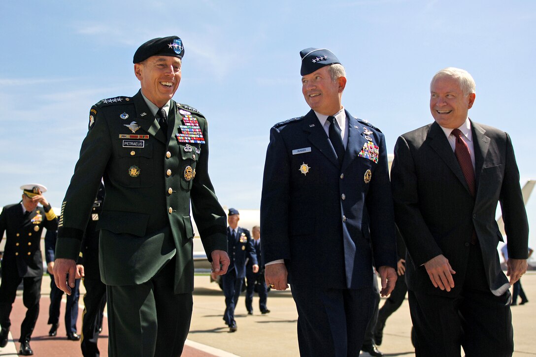 Defense Secretary Robert M. Gates, right, walks with Army Gen. David H. Petraeus, commander, U.S. Central Command, left, and Air Force Gen. Duncan McNabb, commander U.S. Transportation Command, center, prior to awarding Transcom with the Joint Meritorious Unit Award during a ceremony on Scott Air Force Base, Ill., April 1, 2010.