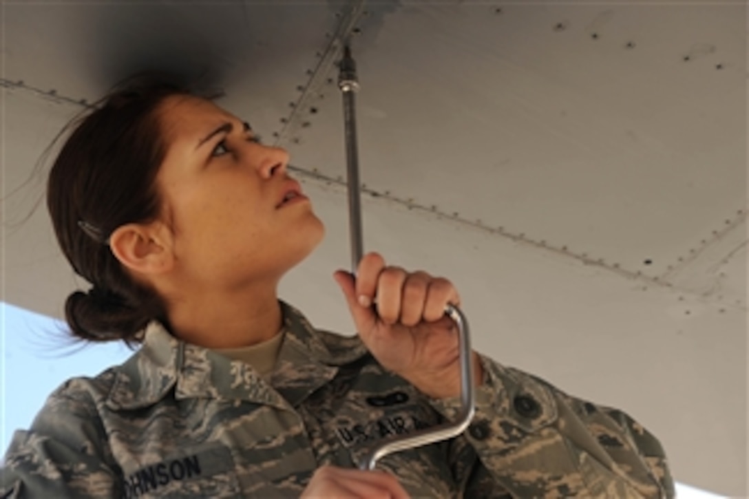 U.S. Air Force Airman 1st Class Erin Johnson, an aircraft fuel systems apprentice assigned to the 28th Maintenance Squadron, removes a dump panel to provide internal maintenance on a B-1B Lancer bomber at Ellsworth Air Force Base, S.D., on March 25, 2010.  