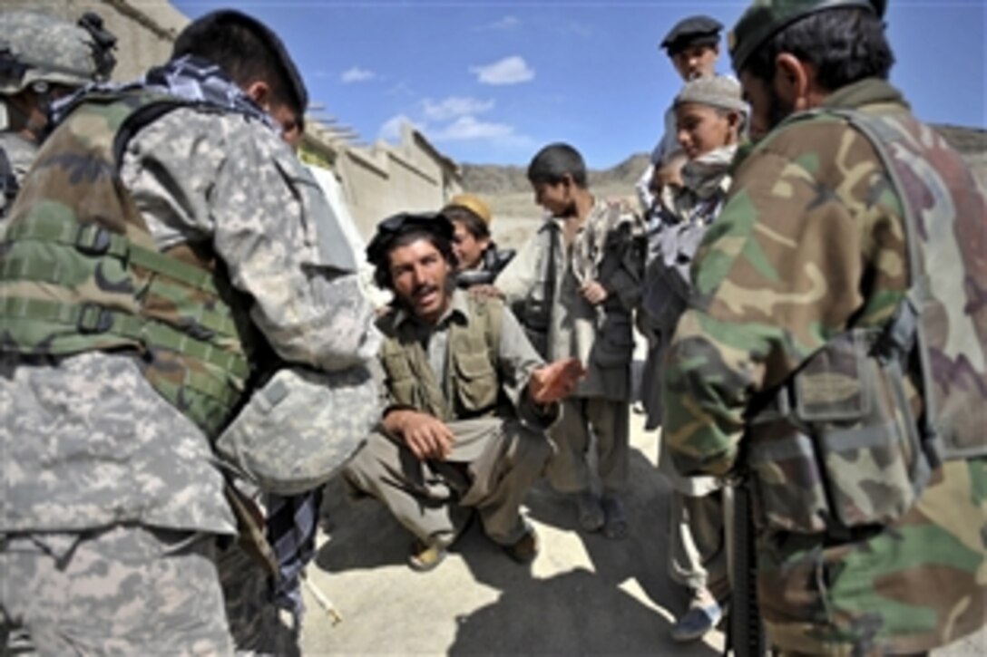 Afghan National Army Capt. Momand Ashaqullah speaks with a Pirkoti village resident in Paktika province, Afghanistan, March 26, 2010. Afghan and U.S. soldiers assigned to the 1st Battalion, 187th Infantry Regiment were in the village to establish relationships with village residents.