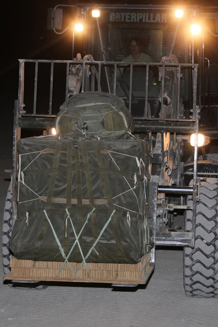 Air delivery specialists from 1st Marine Logistics Group (Forward) and 2nd Marine Logistics Group load a C-130 Hercules with food and water to be transported to Marines in the fight, from Camp Bastion, Afghanistan, April 2.