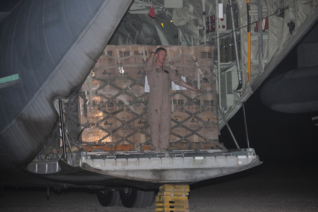 An aircrew Marine directs a 10,000-pound capacity forklift to unload supplies from a C-130 cargo plane at Camp Bastion, Afghanistan, April 2.  Air delivery specialists from 1st Marine Logistics Group (Forward) and 2nd Marine Logistics Group can resupply units at other forward operating bases by air, eliminating the threat of improvised explosive devices.