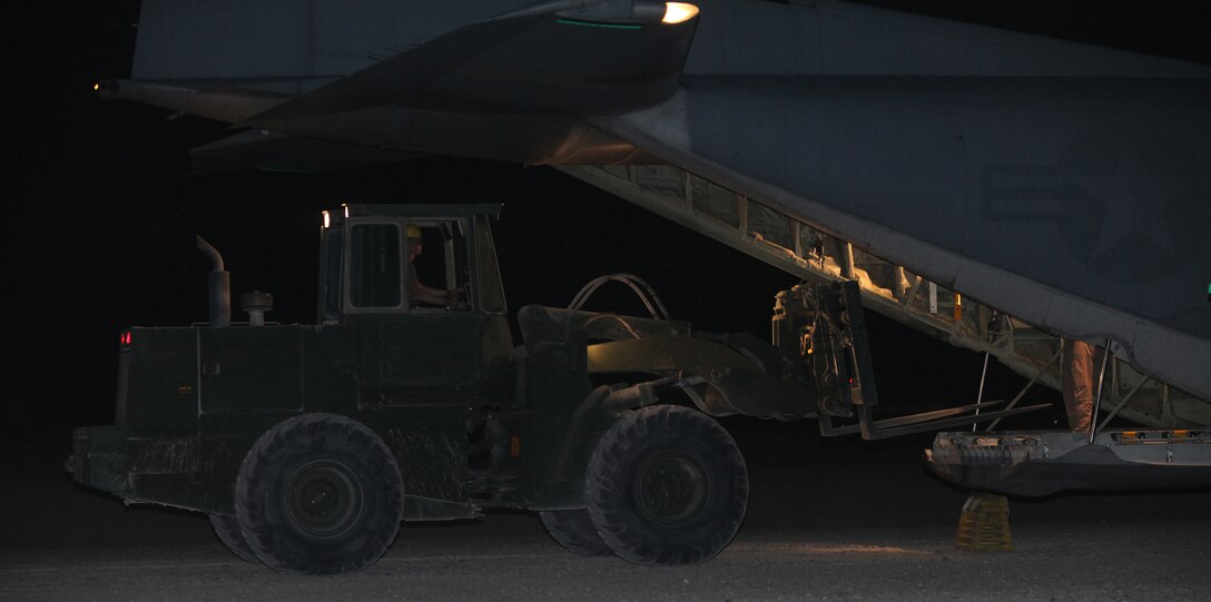 Air delivery specialists from 1st Marine Logistics Group (Forward) and 2nd Marine Logistics Group load up a C-130 Hercules with food and water to be transported to Marines in the fight, from Camp Bastion, Afghanistan, April 2.  A C-130 can carry up to 16 containerized bundles, about 25,000 pounds, containing food, water and fuel, which are flown to troops at forward operating bases or combat outposts.