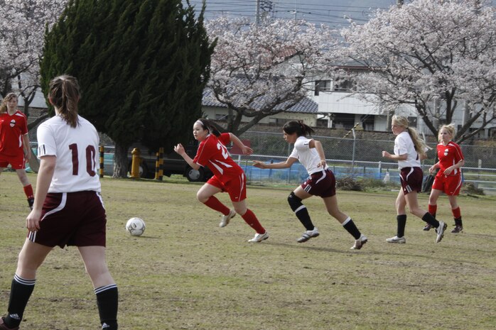 Victoria Pelletier, Matthew C. Perry High School player, chases Celica Levy, a Kinnick High School player, to prevent her from taking the ball down field during the soccer match at M.C. Perry soccer field here April 22.