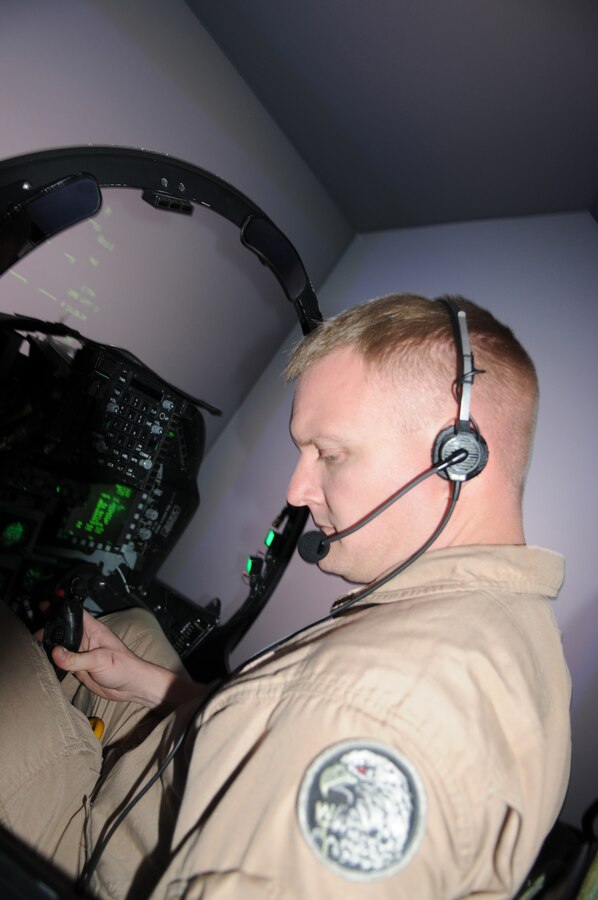 Maj. Casey Elam, Marine Attack Squadron 211 pilot and maintenance officer, practices in an AV-8B Harrier flight simulator at the Marine Corps Air Station in Yuma, Ariz., April 2, 2010. Elam was one of nine Marines selected in 2010 for the U.S. Naval Test Pilot School in Patuxent River, Md. “This has been a dream of mine since I was a young person,” said Elam. “It’s my honor to have this opportunity to learn and grow as an aviator.” The yearlong school tests pilots on their handling of multiple aircraft and understanding of various weapons and navigation systems.