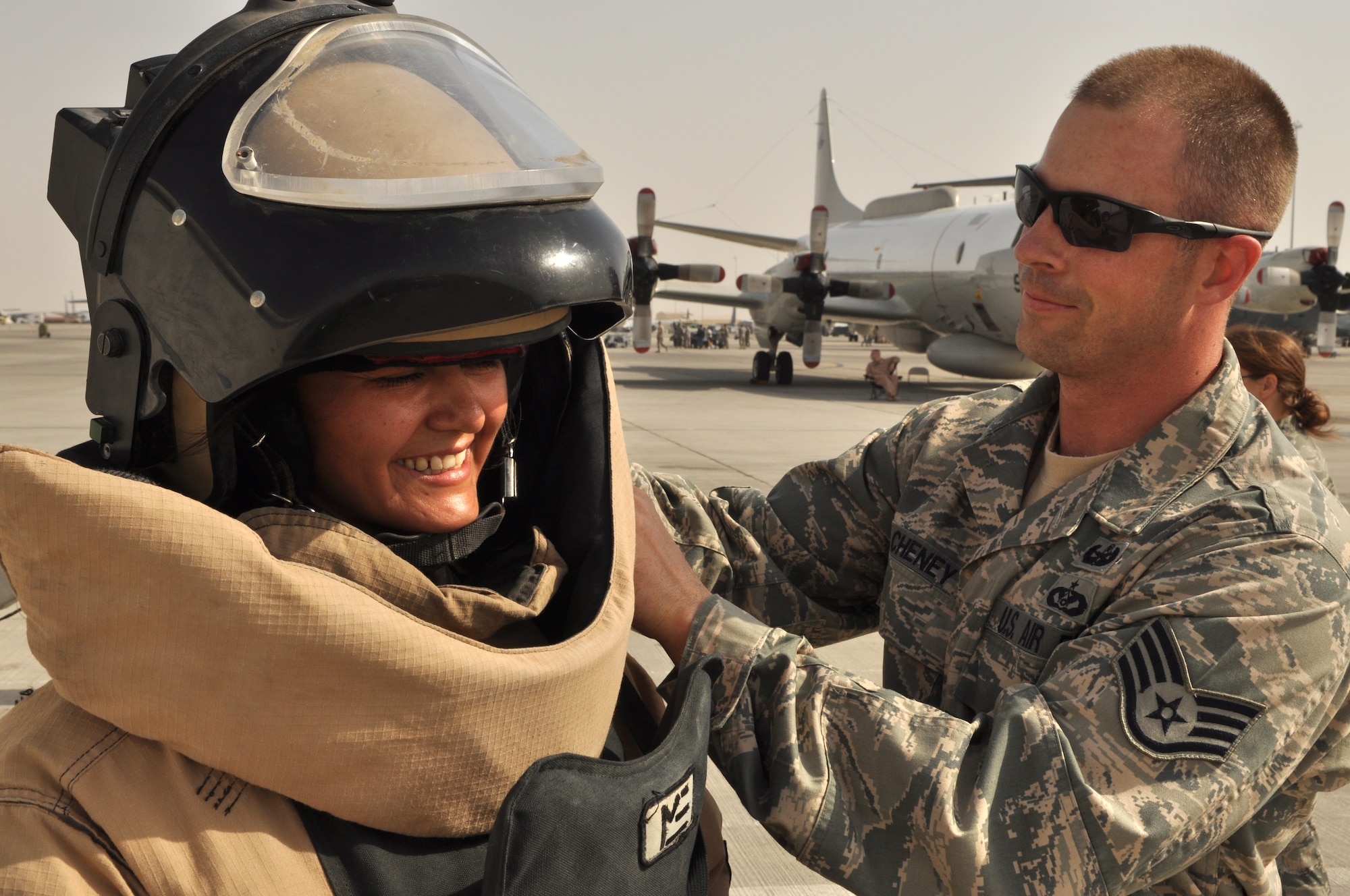 Staff Sgt. Noah Cheney, 379th Expeditionary Civil Engineer Squadron explosive ordnance disposal operator, suits up Staff Sgt. Bilma Romero, 379th Air Expeditionary Wing ground safety technician, in an EOD  suit during Air Fest '10 at a non-disclosed Southwest Asia location April 1, 2010. (U.S. Air Force photo by Capt. Patrick Cordova)[RELEASED]