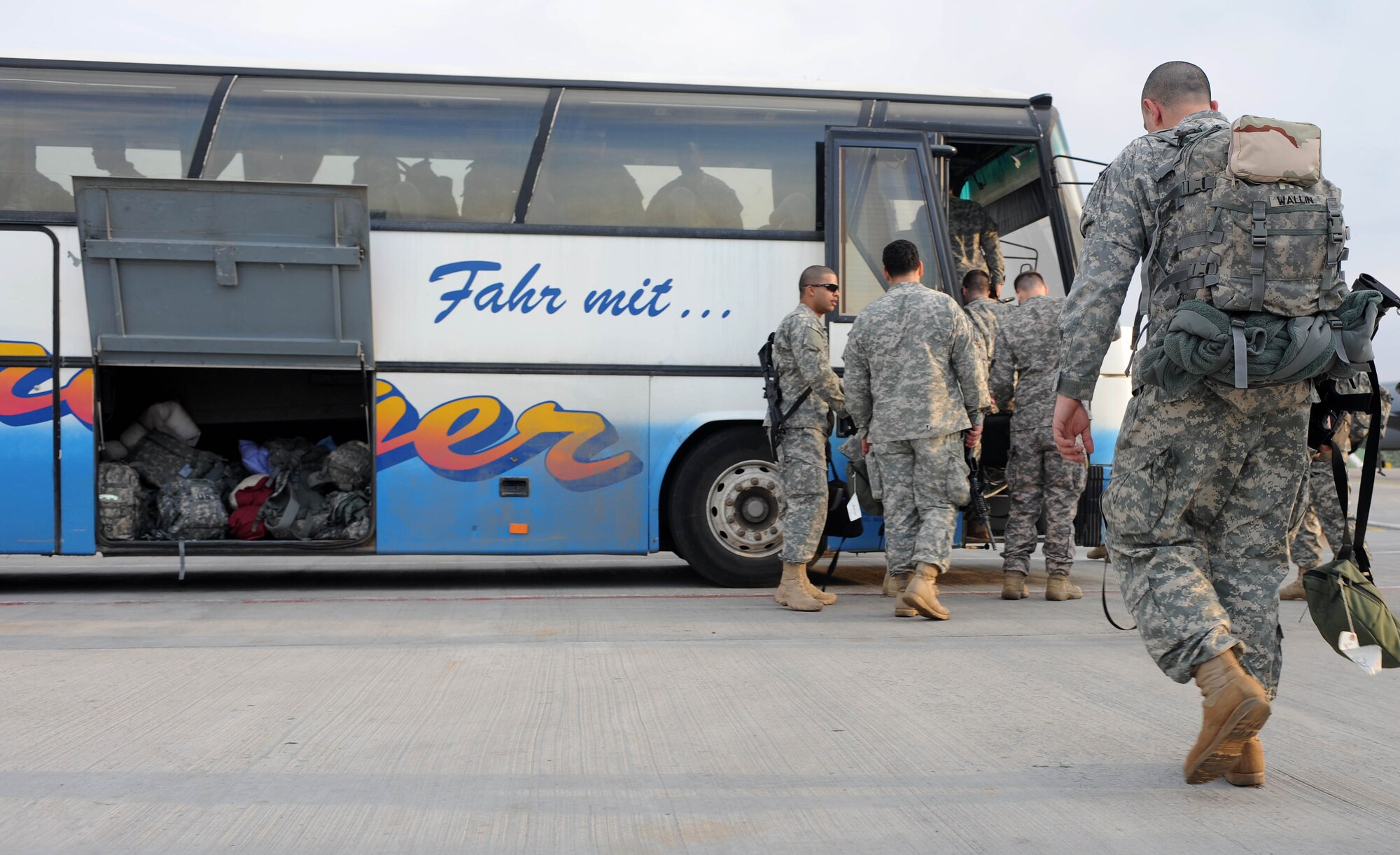 Soldiers from the 557th Engineer Company, 864th Engineer Battalion, Ft. Lewis Wash., load onto a bus transporting them for in processing after arrival to the Transit Center at Manas, Kyrgyzstan April 1, 2010. The Soldiers are transiting through en route to, Afghanistan. The 376th Expeditionary Logistics Readiness Squadron broke two of their own records in March, for most passengers moved and most fuel pumped here, at the "gateway to Afghanistan." The passenger terminal pushed through 50,000 multi-national, U.S. and coalition troops, and the petroleum, oil and lubricants flight issued 12,500,102 gallons of jet fuel in March. (U.S. Air Force photo/Senior Airman Nichelle Anderson/released)
