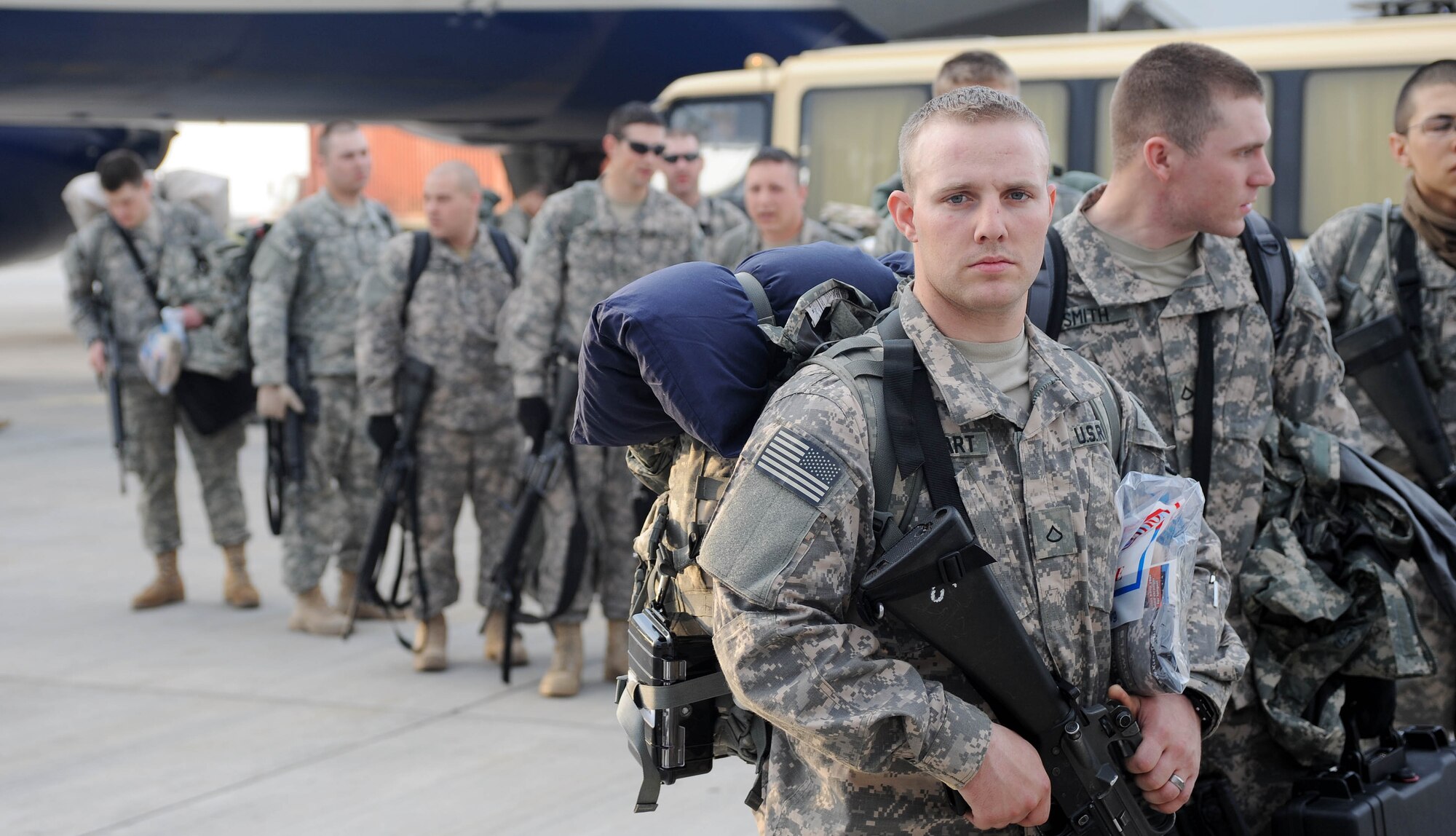 Soldiers from the 557th Engineer Company, 864th Engineer Battalion, Ft. Lewis Wash., load onto a bus transporting them for in processing after arrival to the Transit Center at Manas, Kyrgyzstan April 1, 2010. The Soldiers are transiting through en route to, Afghanistan. The 376th Expeditionary Logistics Readiness Squadron broke two of their own records in March, for most passengers moved and most fuel pumped here, at the "gateway to Afghanistan." The passenger terminal pushed through 50,000 multi-national, U.S. and coalition troops, and the petroleum, oil and lubricants flight issued 12,500,102 gallons of jet fuel in March. (U.S. Air Force photo/Senior Airman Nichelle Anderson/released)