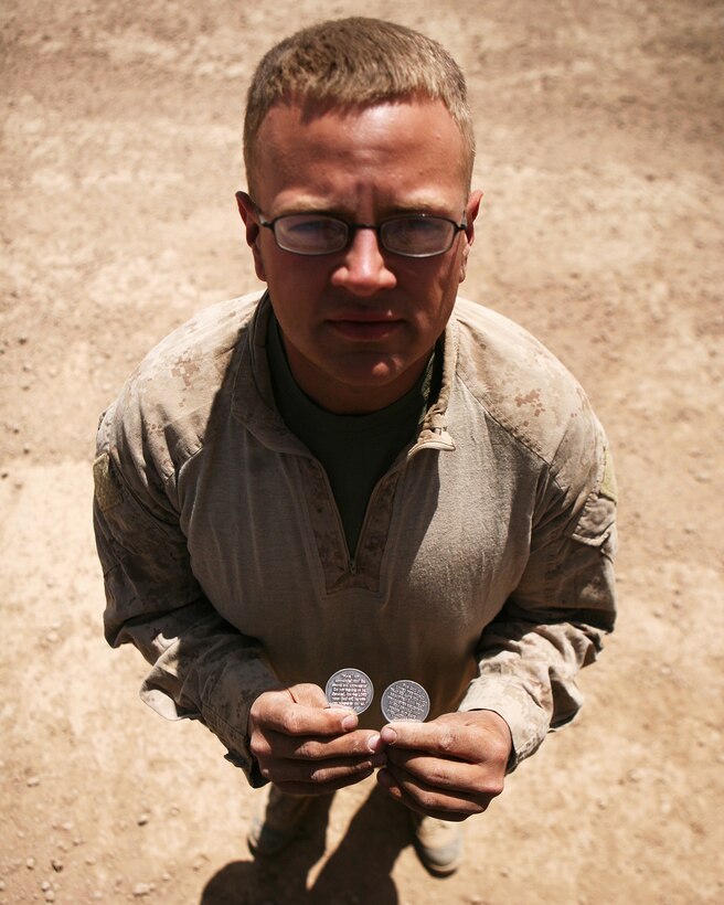 To help him feel more comfortable during combat logistics patrols throughout Helmand province, Lance Cpl. James Vanvalkenburg, a motor transportation operator with Combat Logisitcs Battalion 6, 1st Marine Logistics Group (Forward), keeps the Lord with him in the form of religious challenge coins as displayed aboard Forward Operating Base Edinbugh, Afghanistan April 4. The Athens, Ga., native received the coins during predeployment training aboard Marine Corps Air Ground Combat Center Twentynine Palms, Calif., and he has kept them close by ever since, including nearly a dozen combat logistics patrols.