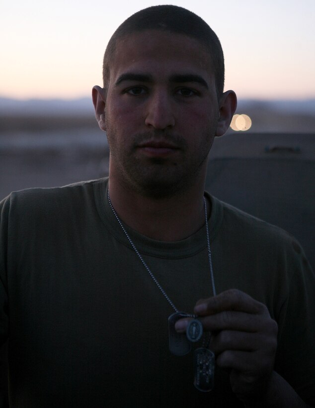 Lance Cpl. Nicholas Randolph, a Logistics Vehicle System operator with Combat Logistics Battalion 6, 1st Marine Logistics Group (Forward), displays a 'good luck' pendant aboard Forward Operating Base Edinburgh, Afghanistan April 3. The pendant was given to him by his mother prior to deploying and like many other Marines in the unit, the 21-year-old Wayne, W.Va., native keeps ensures it accompanies him each time he embarks on another combat logistics patrol in the enemy-saturated Helmand province.