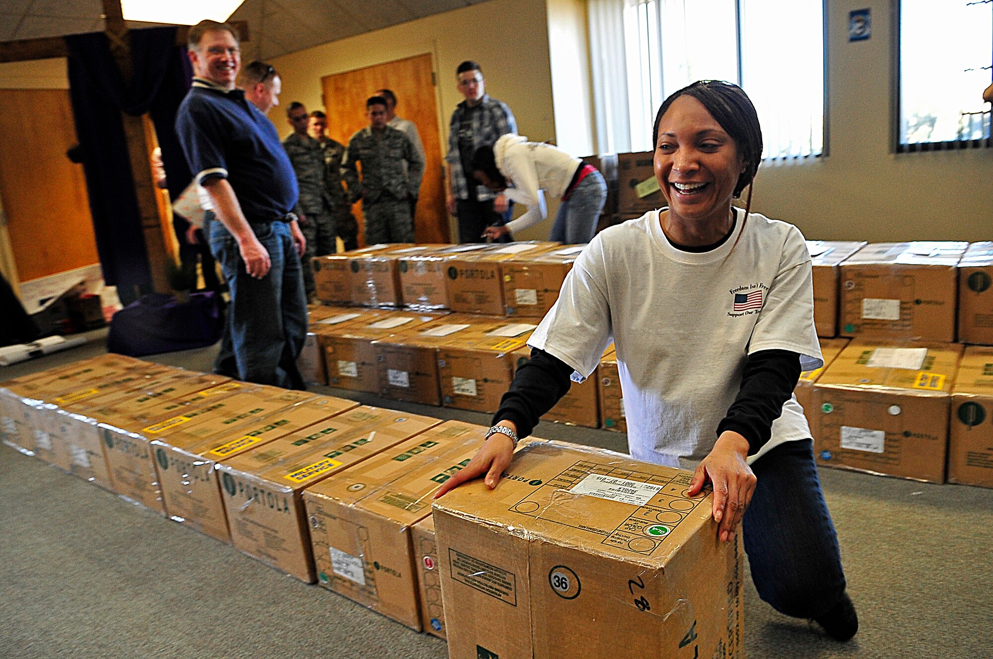 BUCKLEY AIR FORCE BASE, Colo. -- Master Sgt. Derinda Johnson, 460th Space Wing first sergeant, volunteers with Hearts Across the Miles March 14. Volunteers from Buckley Air Force Base and the local community came together to pack more than 300 cases of cookies. (U.S. Air Force photo by Staff Sgt. Kathrine McDowell)
