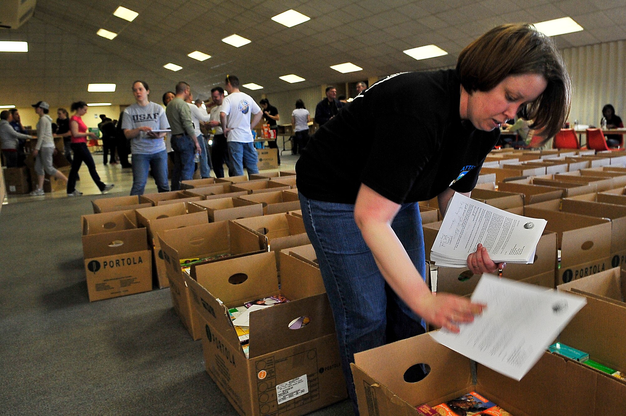 BUCKLEY AIR FORCE BASE, Colo. -- Staff Sgt. Kasabyan Musal, Air Force Technical Applications Center Detachment 45, places thank-you letters into boxes of cookies March 14. The cookies will be sent to deployed U.S. troops. (U.S. Air Force photo by Staff Sgt. Kathrine McDowell)