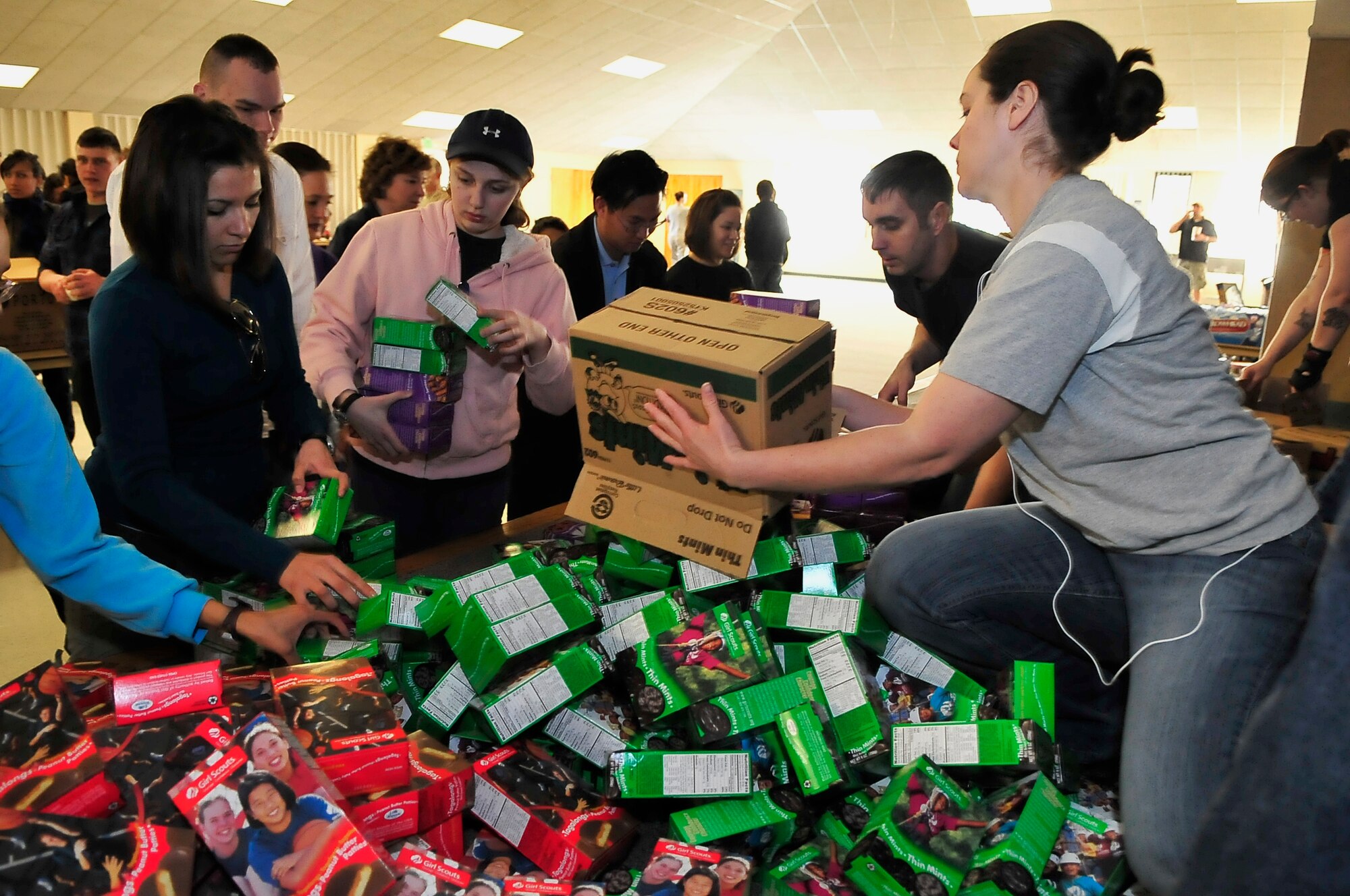 BUCKLEY AIR FORCE BASE, Colo. -- Tech. Sgt. Jill LaVoie, 460th Space Wing Public Affairs superintendent, helps sort boxes of cookies for Hearts Across the Miles March 14. Hearts Across the Miles is a non-profit organization that utilizes volunteer support to send care packages to deployed troops in Iraq and Afghanistan. (U.S. Air Force photo by Staff Sgt. Kathrine McDowell)