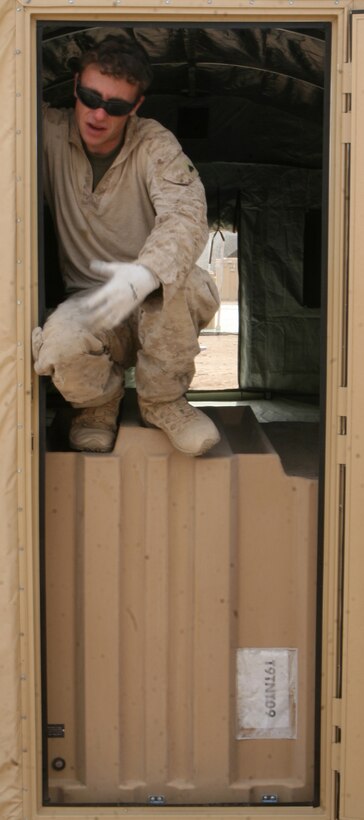 Corporal Daniel Medley, a fireteam leader with 1st Combat Engineer Battalion, attached to 3rd Battalion, 6th Marine Regiment, takes a break from assembling tents at Forward Operating Base Sher Wali, Marjah, Helmand province, Afghanistan, April 6, 2010. The large tents, complete with electricity, lighting and air-conditioning, are the latest structures the engineers have built since arriving to Afghanistan back in January.