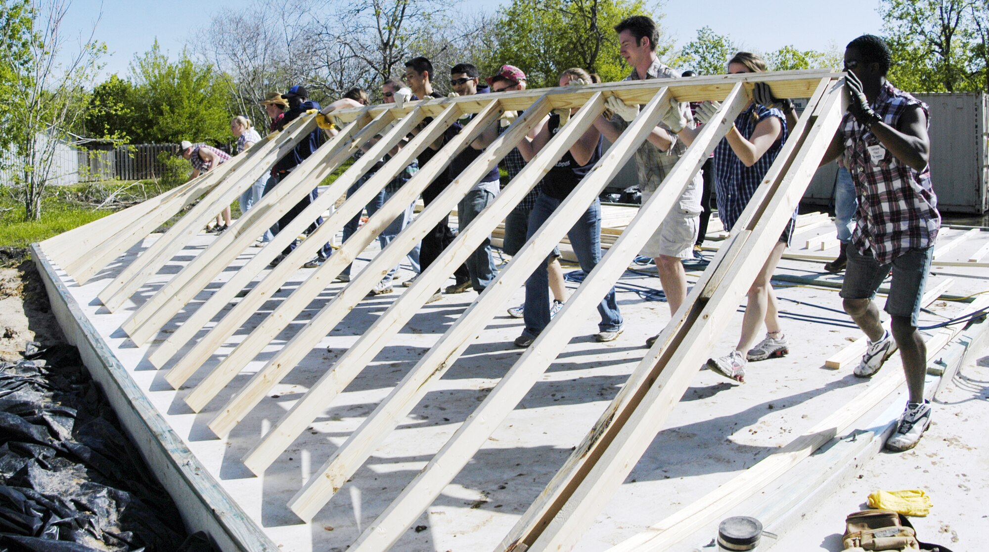 U.S. Air Force Academy cadets lift the west wall of a home during a Habitat for Humanity project March 22, 2010, in Victoria, Texas. Cadets volunteered for the project as part of the Academy's alternative spring break program. (U.S. Air Force photo/John Van Winkle)