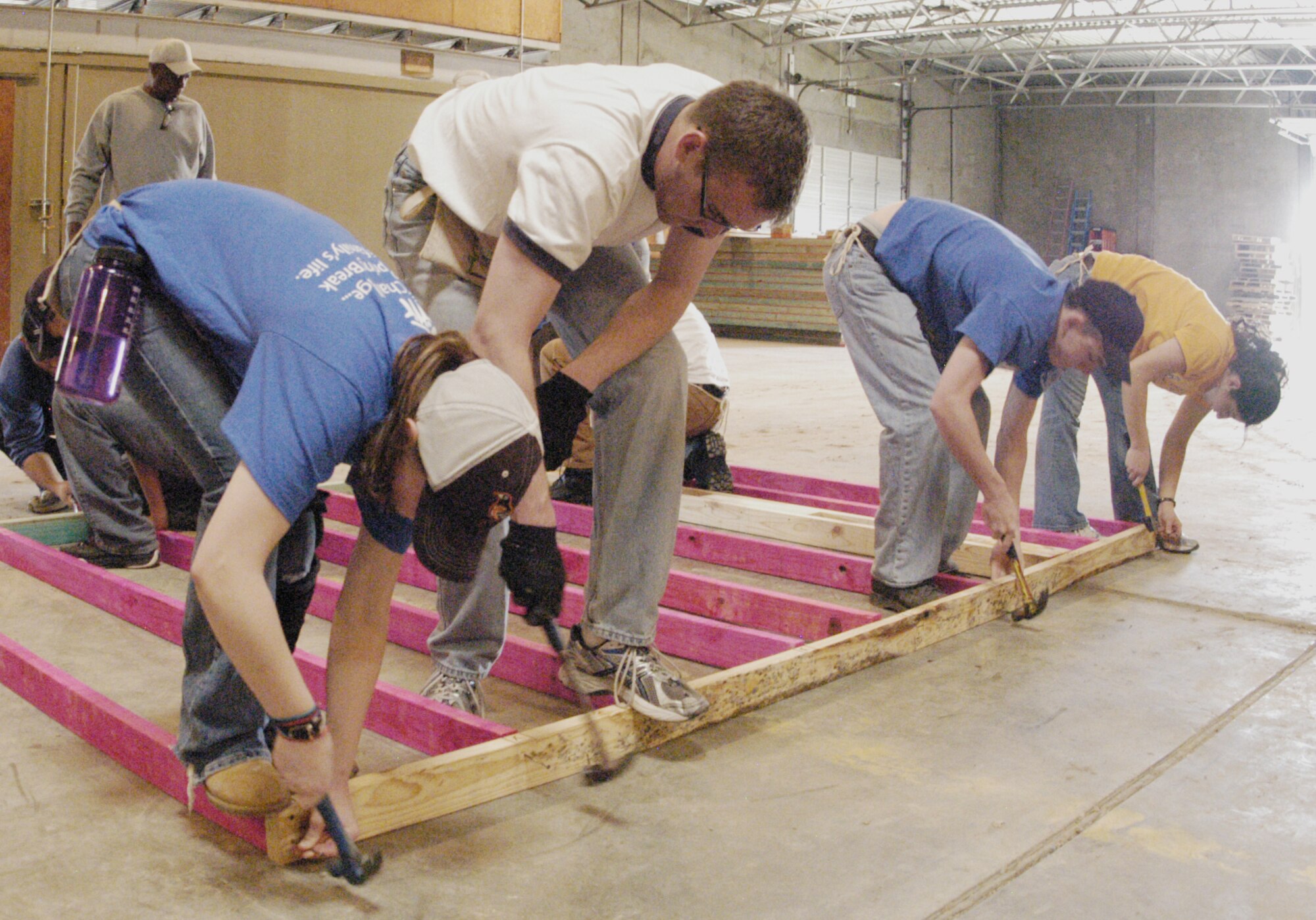 U.S. Air Force Academy Cadets 3rd Class Kirby Forssell and Chris Miller, Cadet 1st Class Michael Bates and Cadet 3rd Class Paola Gavilanes assemble a wall frame March 23, 2010, in Bryan, Texas. The cadets volunteered to travel to the small Texas town and build homes as part of an alternative spring break March 20 through 26. (U.S. Air Force photo/John Van Winkle)