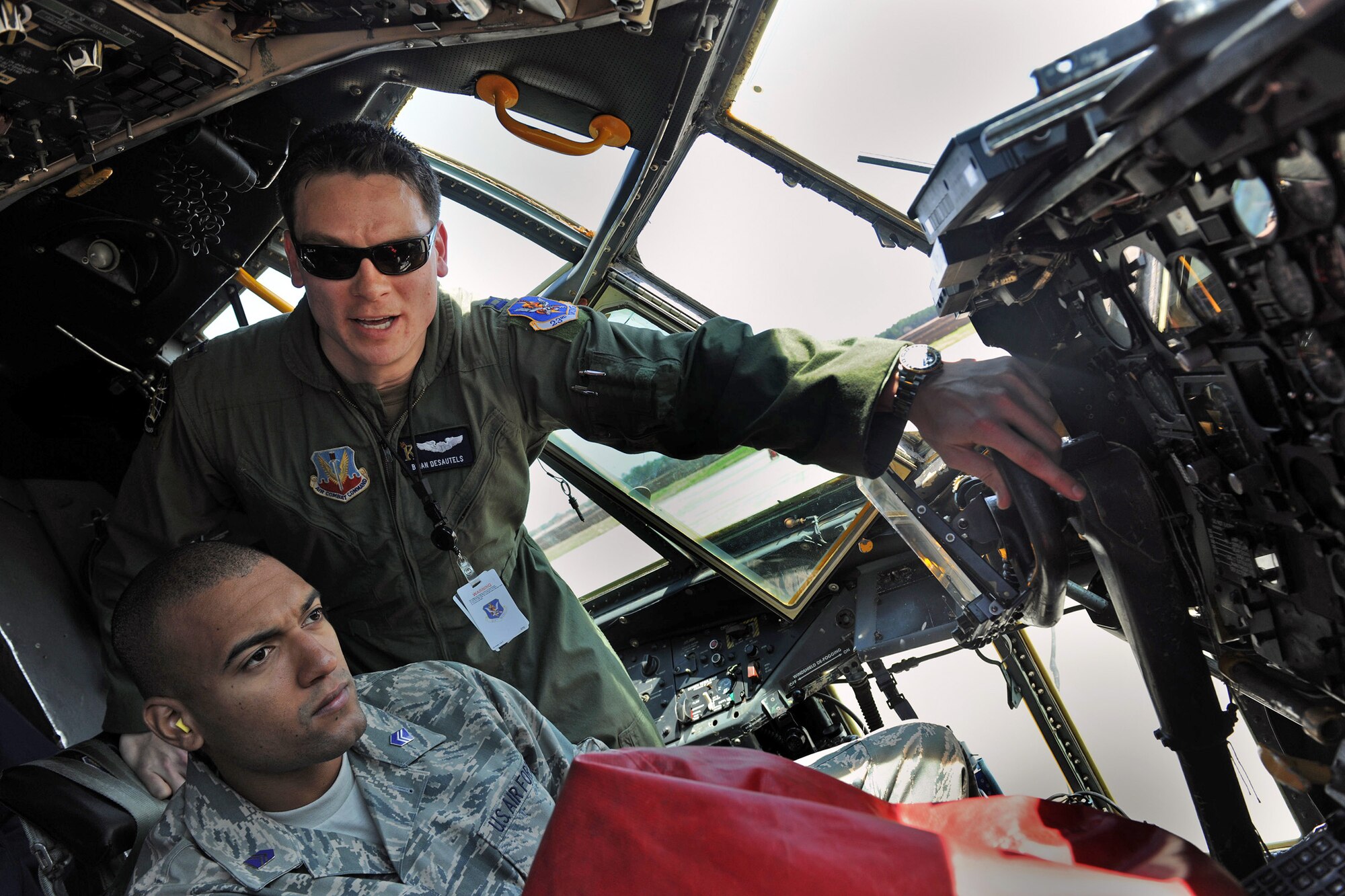 Capt. Brian Desautels gives a tour of a C-130 Hercules cockpit to Cadet 3rd Class Bruce Padilla from the University of Puerto Rico Air Force ROTC Detachment 755 during a base tour March 23, 2010, at Moody Air Force Base, Ga. Captain Desautels is the 71st Rescue Squadron mobility flight commander. (U.S. Air Force photo/Airman 1st Class Benjamin Wiseman)