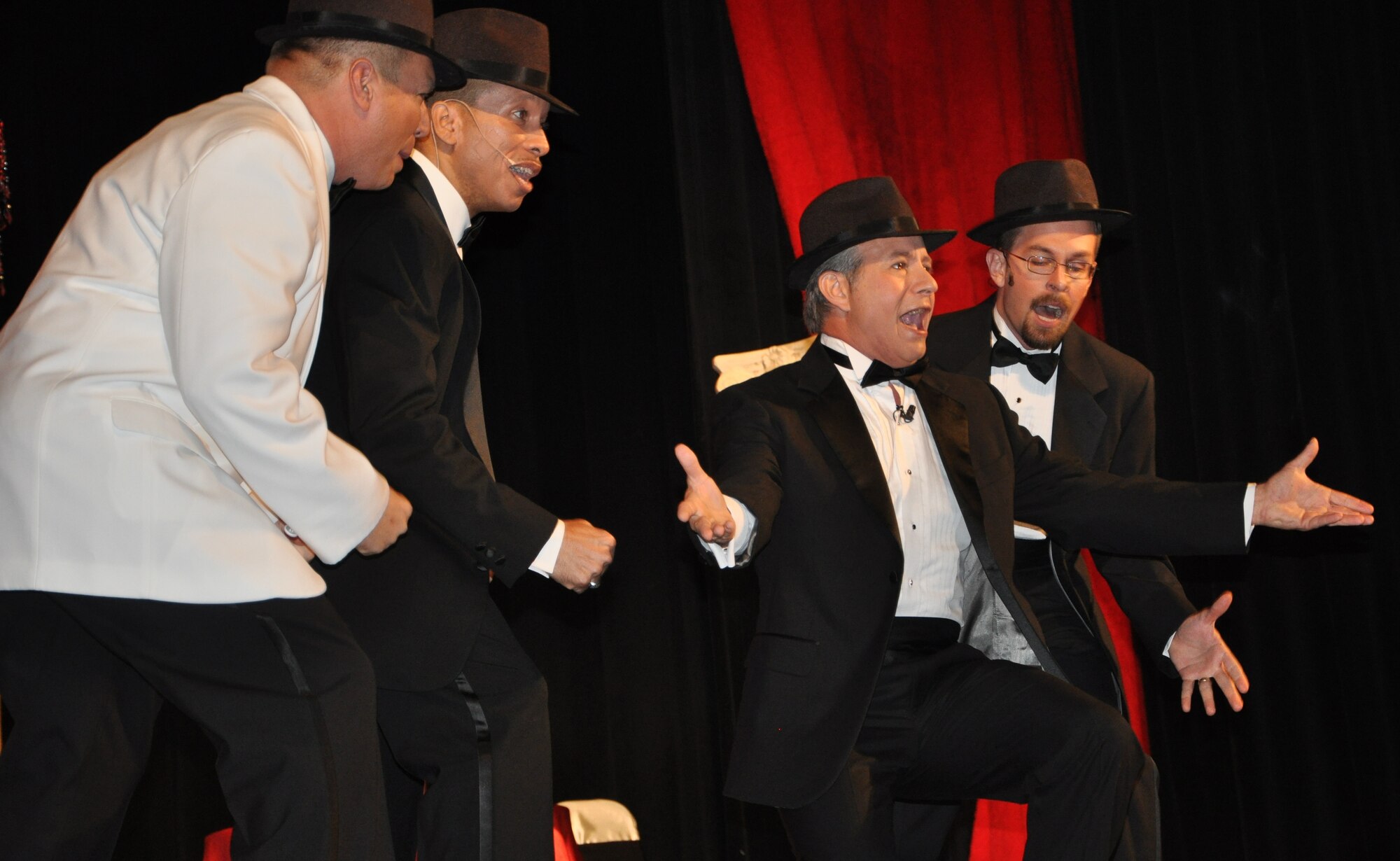 LAUGHLIN AIR FORCE BASE, Texas – Lt. Col. Matt Harper, 47th Operations Support Squadron, Master Sgt. Keith Martin, 96th Flying Training Squadron, Robert Wade, 47th Flying Training Wing, and Ben Graff, 47th Installation Support Squadron, sing a classic Frank Sinatra song during the Upstagers’ performance at the Paul Poag Theater in Del Rio April 2. The Upstagers are a Del Rio-based, completely volunteer theater group that was formed in 1977. (U.S. Air Force photo by Airman 1st Class Blake Mize)