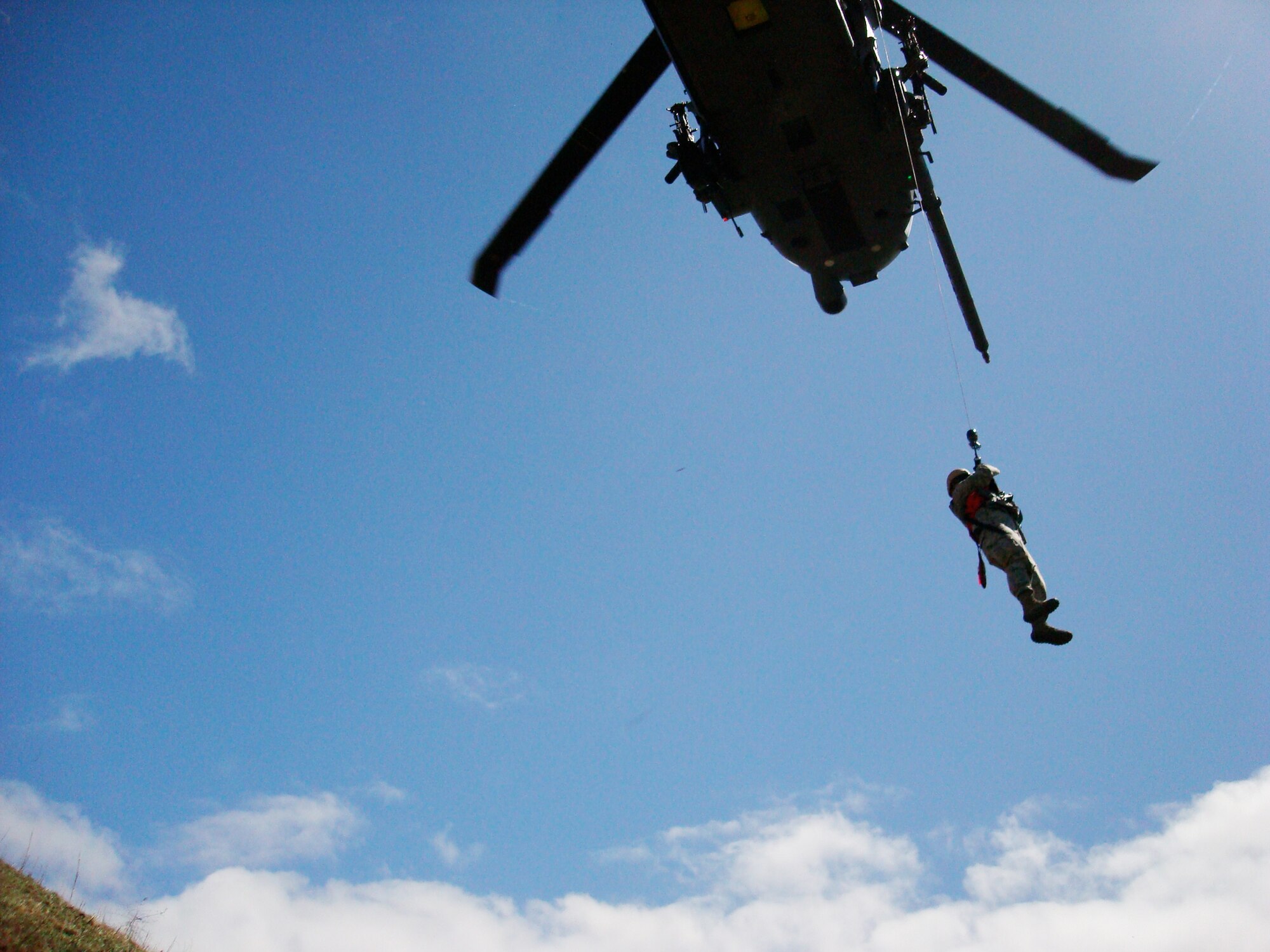 Maj. Thomas Ikehara is hosted up a helicopter during a simulated downed pilot scenario as part of exercise Balikatan 2010 March 20, 2010, in the Philippines. Balikatan is an annual bilateral exercise designed to increase interoperability between the U.S. and Philippine air forces, and exercises the two nation's ability to operate together when responding to natural disasters. Major Ikehara is from the Hawaii Air Support Operations Center deployed to the Philippines from Joint Base Pearl Harbor-Hickam, Hawaii. (U.S. Air Force photo)