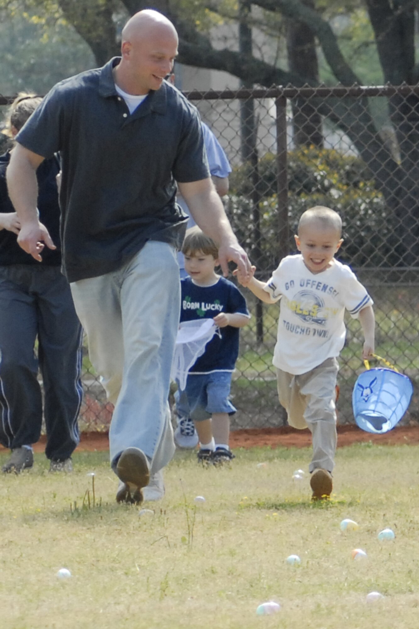 A father and son race to collect eggs at the tenth annual Family Fest and Egg Hunt at the Hurlburt Field Community Park April 3. Within a minute, the children snatched up nearly 16,000 candy and treat-filled eggs. (U.S. Air Force photo by Airman 1st Class Joe McFadden)