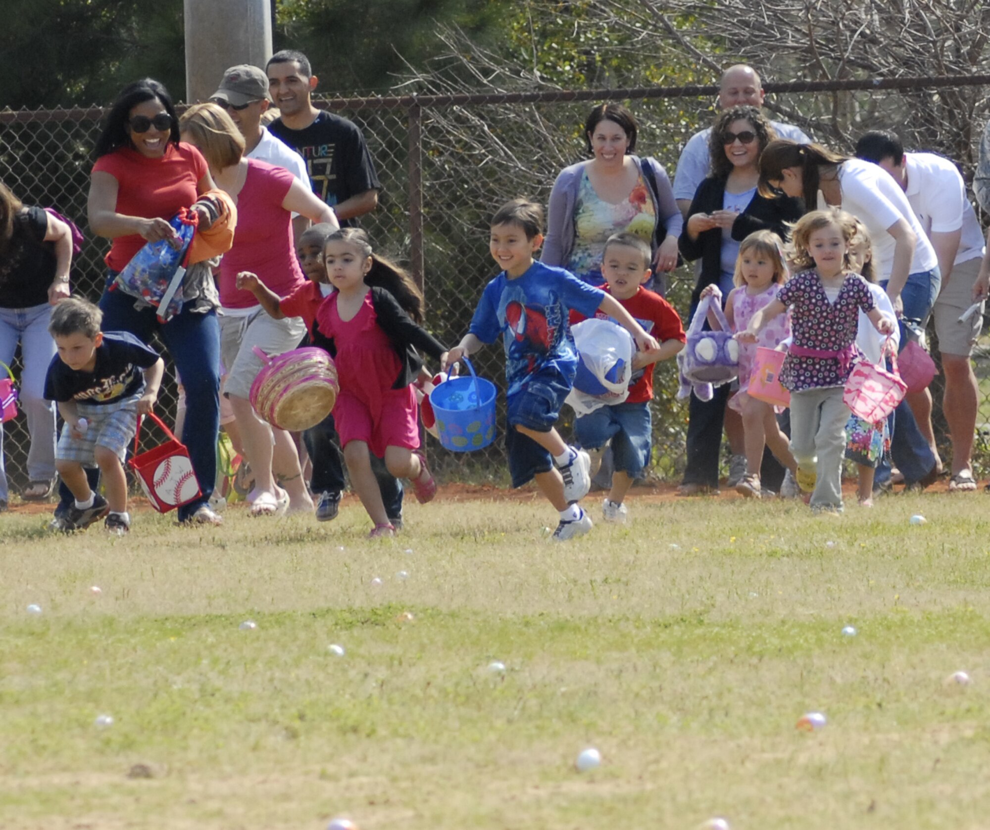 Children race to collect eggs at the tenth annual Family Fest and Egg Hunt at the Hurlburt Field Community Park April 3. Within a minute, the children snatched up nearly 16,000 candy and treat-filled eggs. (U.S. Air Force photo by Airman 1st Class Joe McFadden)