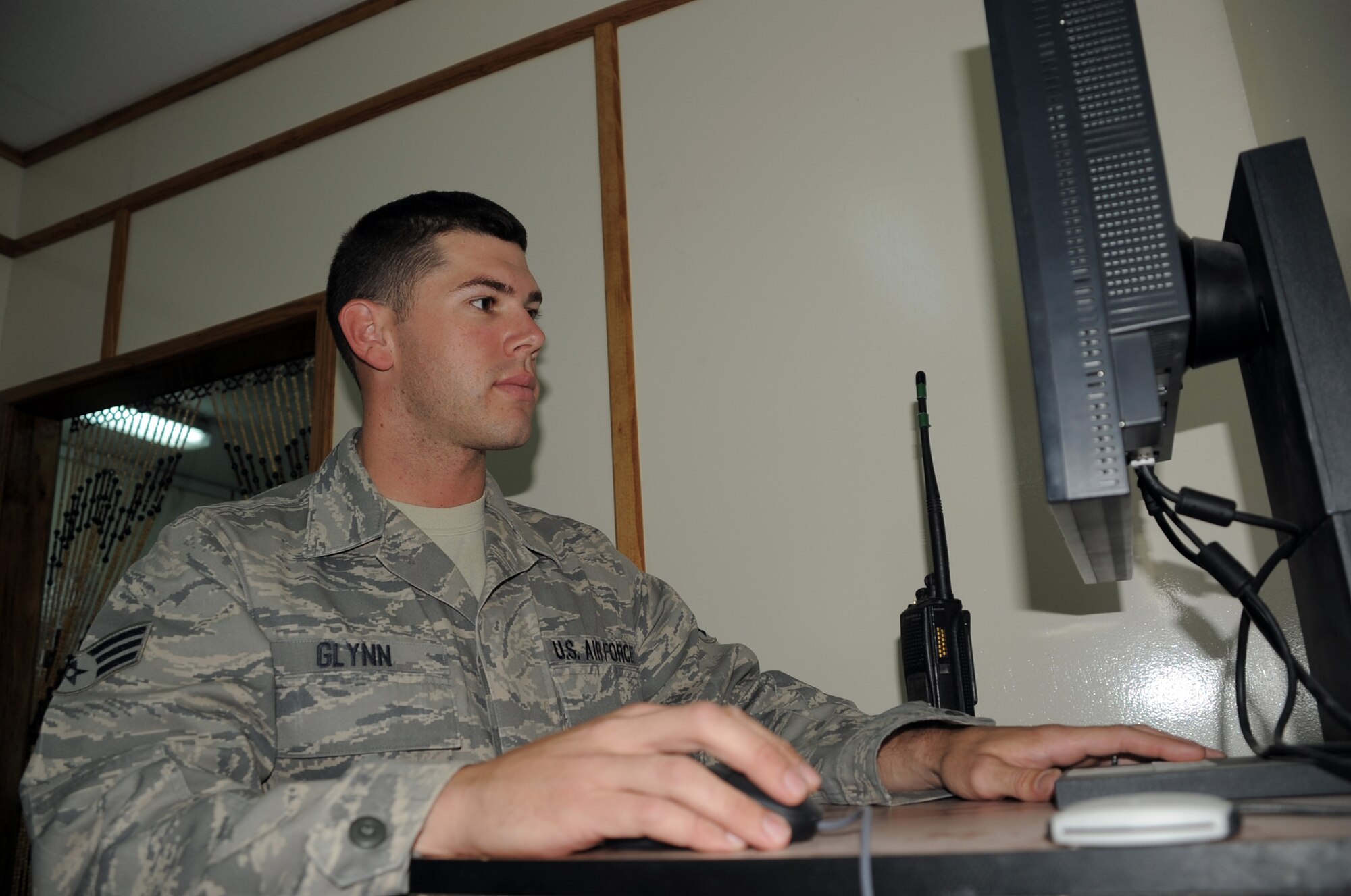 Senior Airman Matthew Glynn, client systems journeyman with the 380th Expeditionary Communications Squadron, works on computer network equipment in a base buidling during operations at a non-disclosed base in Southwest Asia on April 5, 2010. According to his official Air Force job description, client systems personnel are the Air Force computer networking specialists. When they are deployed, they sustain, troubleshoot and repair standard voice, data, video network and cryptographic client devices. Airman Glynn is deployed from the 92nd Communications Squadron at Fairchild Air Force Base, Wash., and his hometown is Larose, La. (U.S. Air Force Photo/Master Sgt. Scott T. Sturkol/Released)