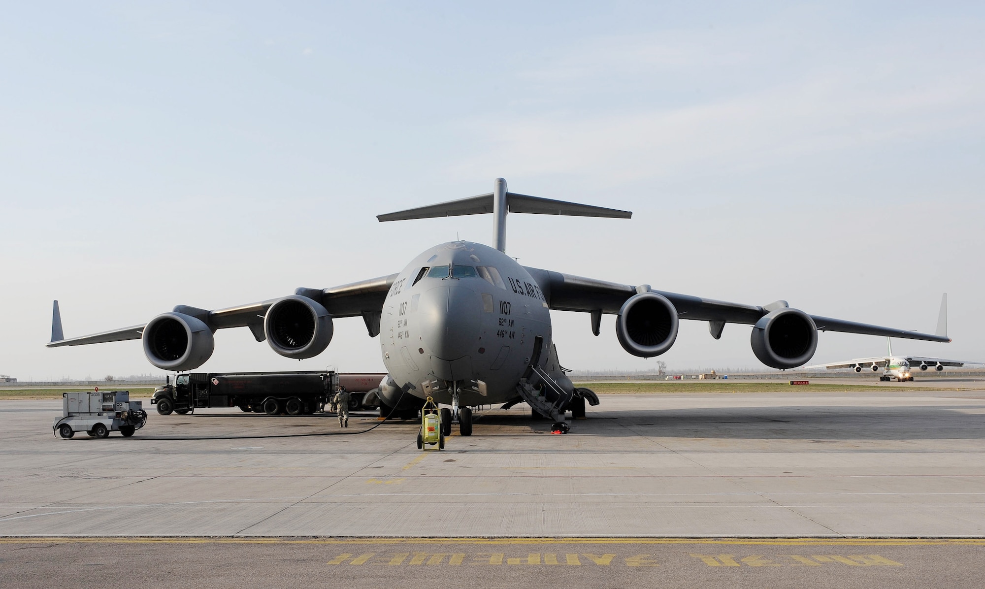 A petroleum, oil and lubricants specialist pumps gas from a fuel truck into a C-17 Globemaster III before its next mission to Afghanistan April 2, 2010, at the Transit Center at Manas, Kyrgyzstan. In March, 376th Expeditionary Logistics Readiness Squadron POL flight Airmen issued 12,500,102 gallons of gas to cargo, tanker and other combat support aircraft. (U.S. Air Force photo/Senior Airman Nichelle Anderson)