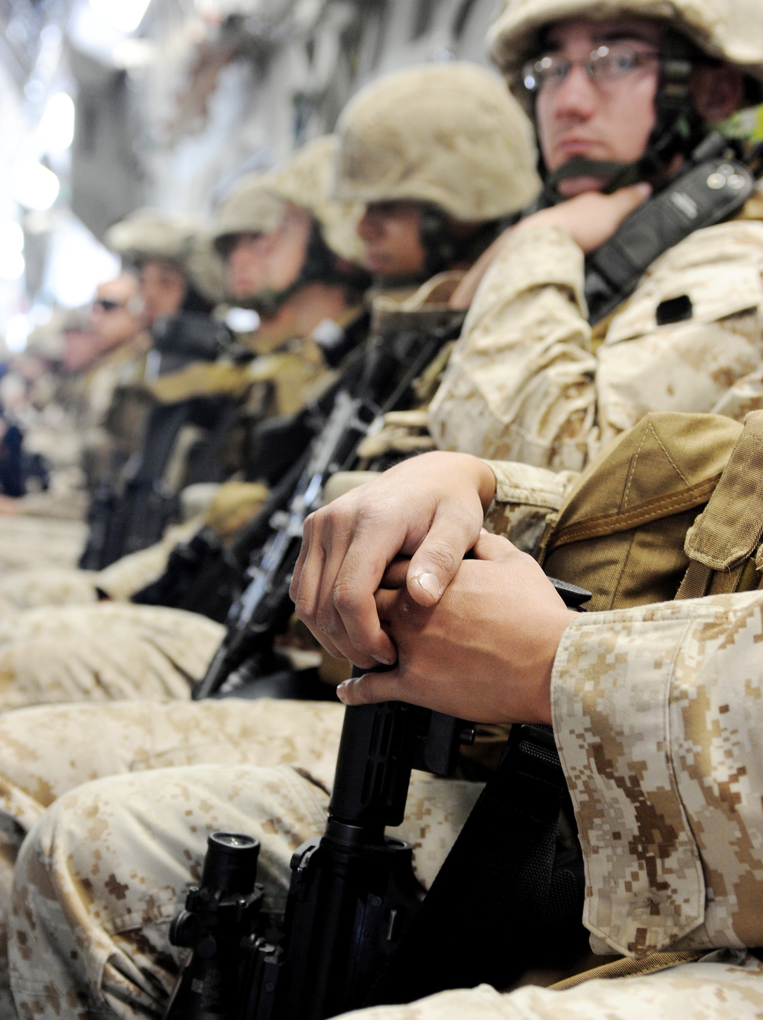 Marines sit on a C-17 Globemaster III en route to Afghanistan April 2, 2010 at the Transit Center at Manas, Kyrgyzstan. Thousands of Marines, Soldiers, Airmen and coalition troops transit through here each month in support of Operation Enduring Freedom. In March, 376th Expeditionary Logistics Readiness Squadron Airmen pushed through 50,000 multinational, U.S. and coalition troops. The Marines are from the 7th Engineer Support Battalion, Marine Corps Base Camp Pendleton, Calif. (U.S. Air Force photo/Senior Airman Nichelle Anderson)