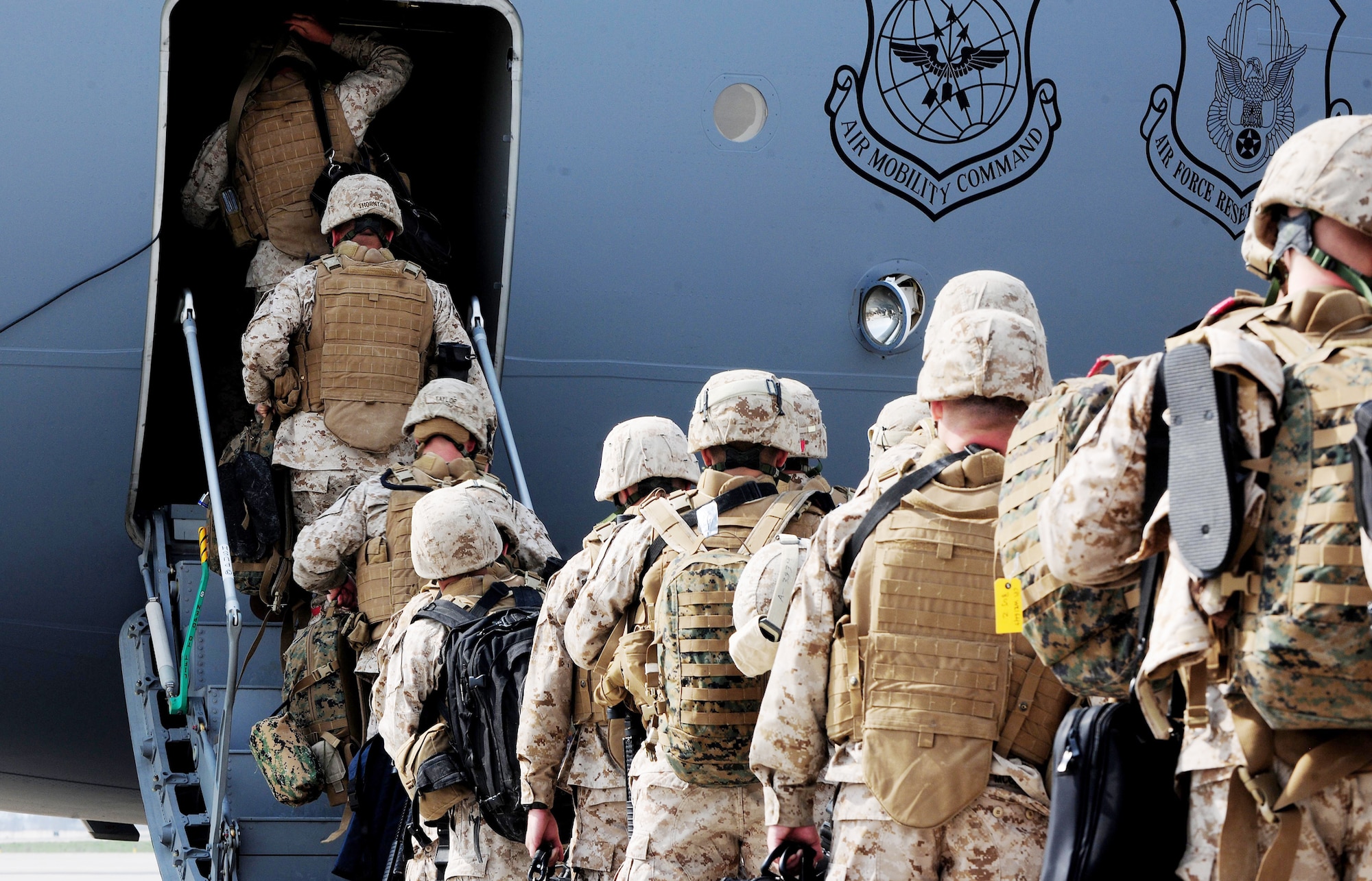 Marines walk onto a C-17 Globemaster III en route to Afghanistan April 2, 2010 at the Transit Center at Manas, Kyrgyzstan. Thousands of Marines, Soldiers, Airmen and coalition troops transit through here each month in support of Operation Enduring Freedom. In March, 376th Expeditionary Logistics Readiness Squadron Airmen pushed through 50,000 multinational, U.S. and coalition troops. The Marines are from the 7th Engineer Support Battalion, Marine Corps Base Camp Pendleton, Calif. (U.S. Air Force photo/Senior Airman Nichelle Anderson)