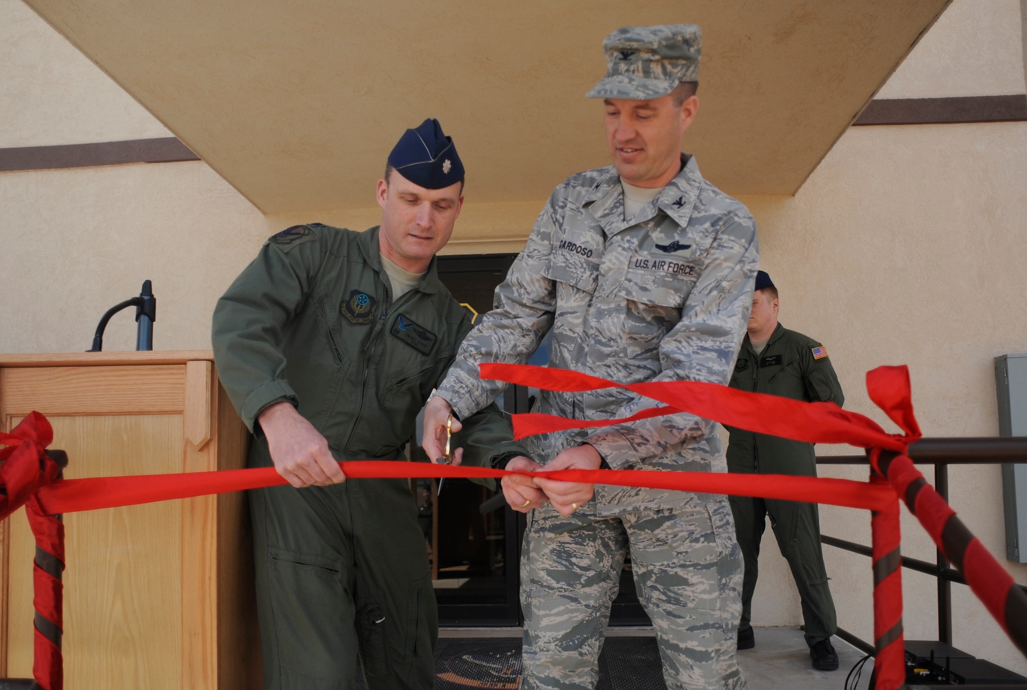 (L-R) Lt. Col Arthur Davis, 551 Special Operations Squadron commander, and Colonel James Cardoso, 27th Special Operations Wing vice commander, cut the ribbon at the new 551 SOS training center April 2. The squadron's cadre trains aircrews on multiple weapons systems on a variety of aircraft. (U.S. Air Force Photo by Senior Airman Evelyn Chavez)