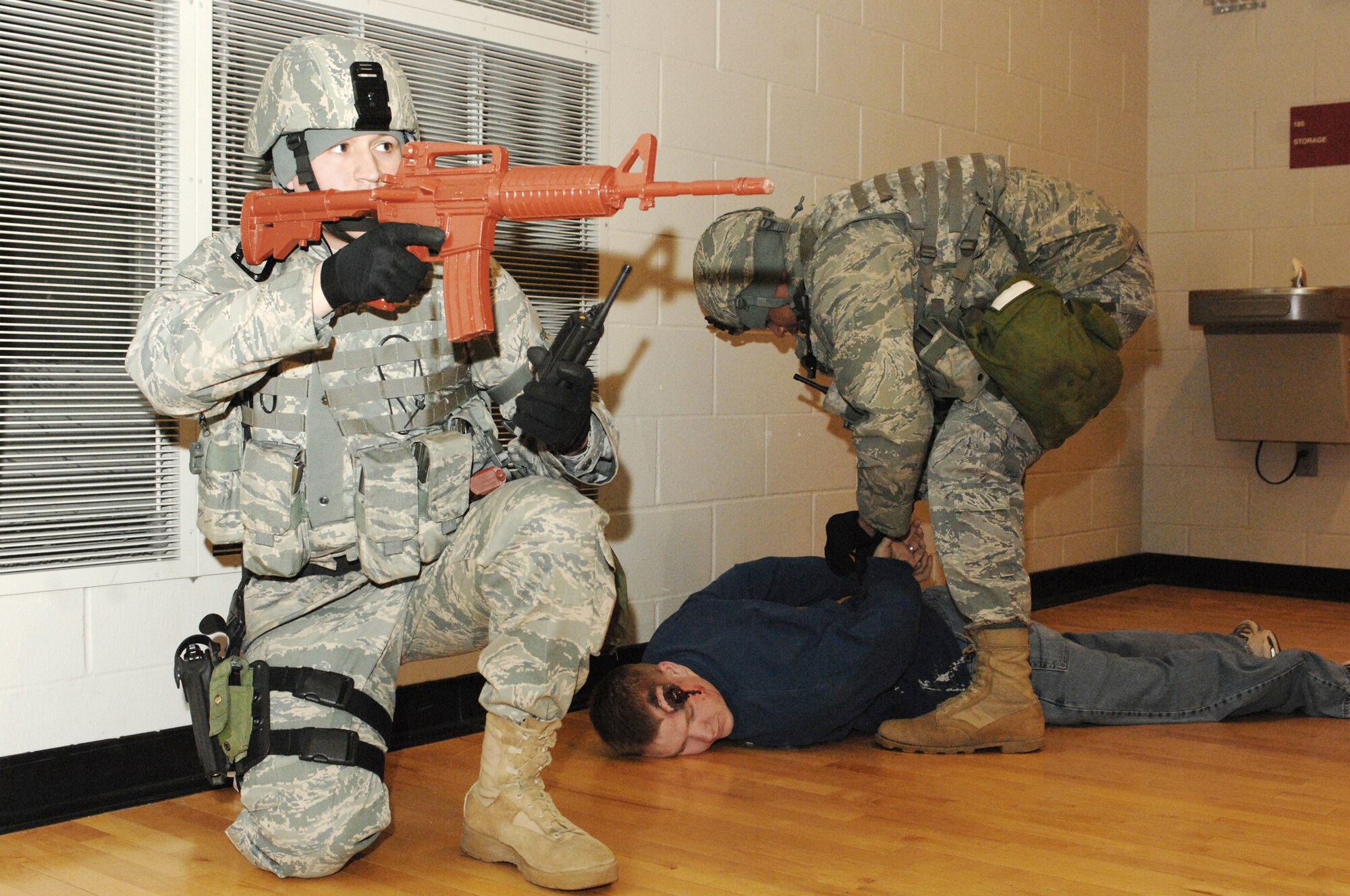 Staff Sgt. Jarrod Nelson provides security while another member of the team detains a possible shooter in the McAdoo Sports and Fitness Center during a major accident response exercise March 26, 2010, at Minot Air Force Base, N.D. The exercise prepared base members for possible real-world situations as well as testing communication and emergency procedures. Sergeant Nelson is a 5th Security Forces Squadron fire team leader. (U.S. Air Force photo/Airman 1st Class Aaron-Forrest Wainwright)