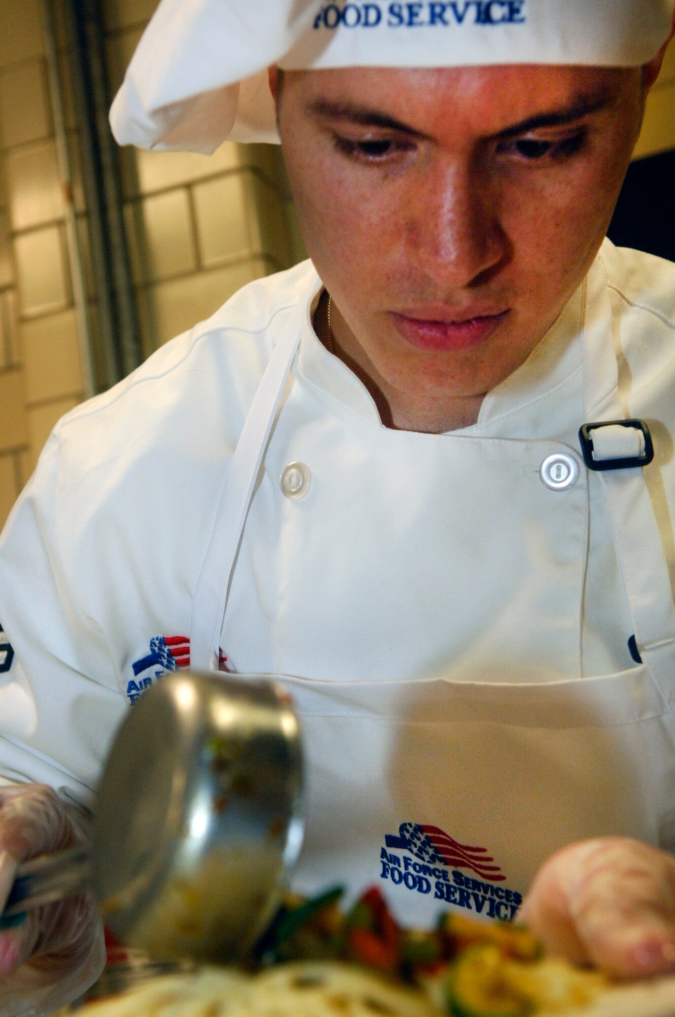 MINOT AIR FORCE BASE, N.D. – Airman 1st Class Moises Gallardo, 741st Missile Squadron missile chef, prepares the final touches to his dish during the 2010 Warrior Chef competition held at the Dakota Inn dining facility on Minot Air Force Base March 30. The competition is an annual contest implemented to give 5th Bomb Wing and 91st Missile Wing chefs the chance to show off their cooking abilities and creativity in a friendly competitive environment.  Each Wing must demonstrate culinary arts and talents in a 60 minute, head-to-head showdown to create the best main dish and side dish. (U.S. Air Force photo by Senior Airman Jesse Lopez)