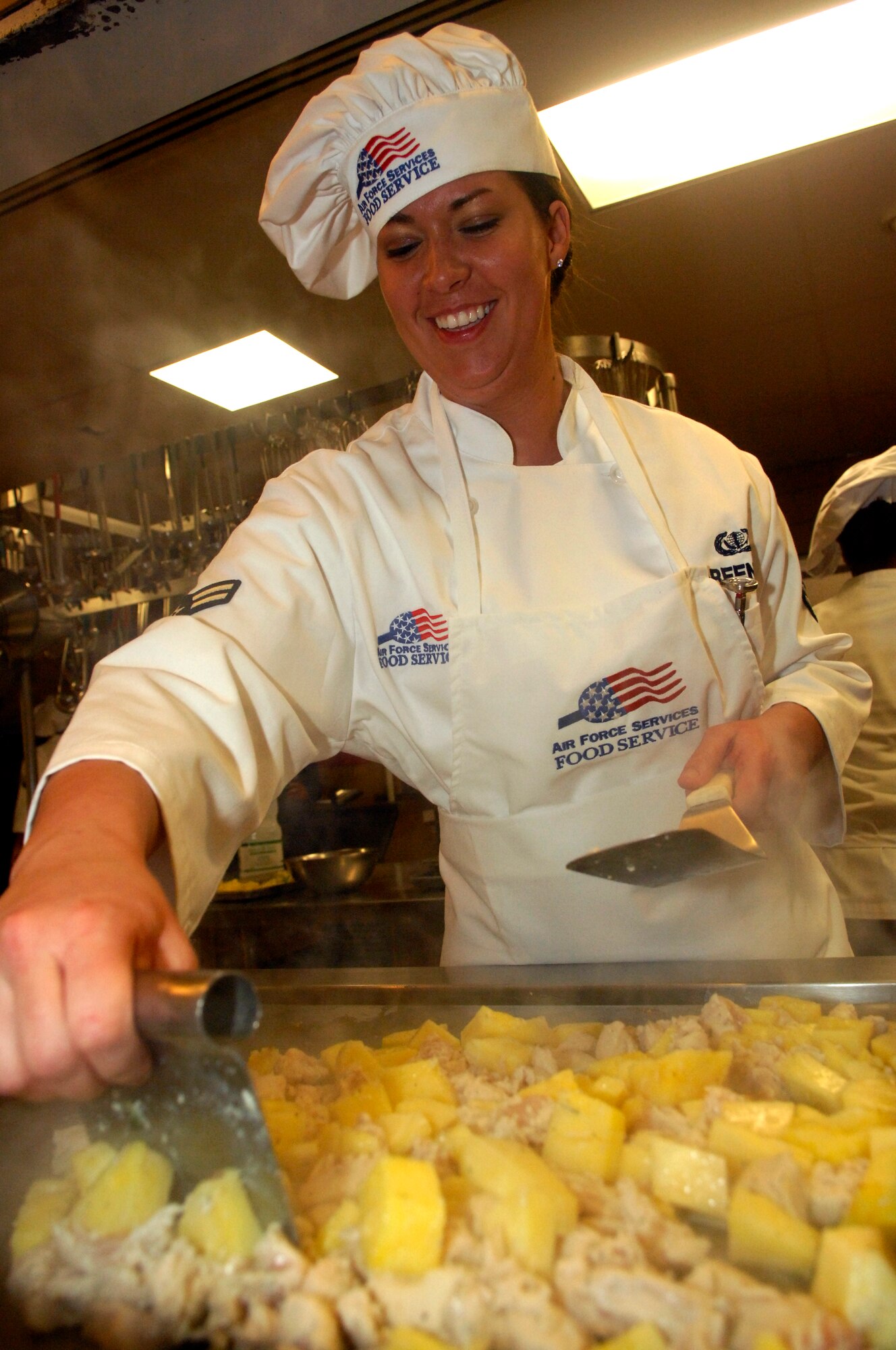 MINOT AIR FORCE BASE, N.D. – Airman 1st Class Amanda Greenlee, 740th Missile Squadron missile chef, fries chicken and pineapples during the 2010 Warrior Chef competition held at the Dakota Inn dining facility on Minot Air Force Base March 30. The competition is an annual contest implemented to give 5th Bomb Wing and 91st Missile Wing chefs the chance to show off their cooking abilities and creativity in a friendly competitive environment.  Each Wing must demonstrate culinary arts and talents in a 60 minute, head-to-head showdown to create the best main dish and side dish. (U.S. Air Force photo by Senior Airman Jesse Lopez)