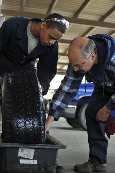 MOODY AIR FORCE BASE, Ga. -- Airman 1st Class Travias Ellison, 23rd Logistics Readiness Squadron vehicle maintenance apprentice, and John Zakar, 23rd LRS service writer, check a tire in order to find a leak here March 29. The 23rd LRS vehicle management flight is responsible for maintaining 51 emergency vehicles, as well as fleet control of more than 438 additional vehicles. (U.S Air Force photo by Staff Sgt. Schelli Jones/RELEASED)