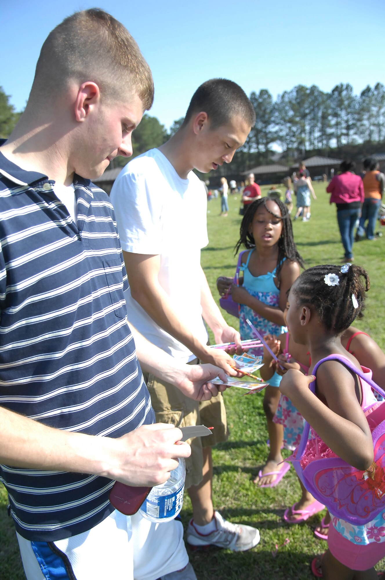 Airmen from the 43rd Security Forces Squadron on Pope give prizes to winners of the spoon races at the Easter Egg Hunt April 2. The event, hosted by the Pope Library and 43rd SFS, gave families a chance to have fun, play games and enjoy the sunshine. (U.S. Air Force Photo by 2nd Lt. Cammie Quinn)